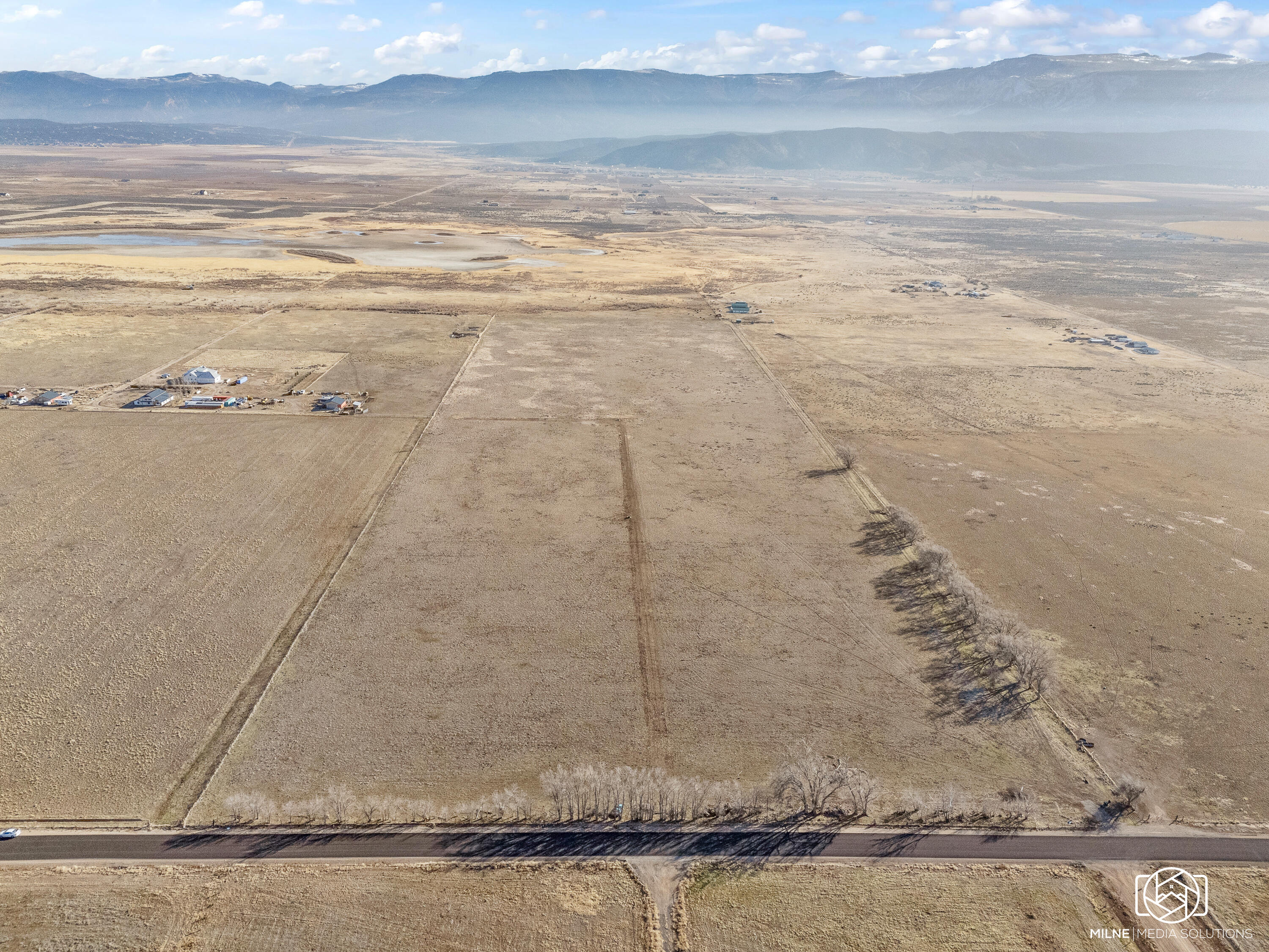 Build Ready 50-acre parcel with water and power for 2 or more homes.

Key features
- 50 acres of flat, build-ready land with limitless potential for a private estate, a boutique community, or a high-value subdivision of multiple homes
- Dramatic panoramic views that stretch to the horizon
- Seller-has 3 home plans available for purchase to jumpstart your development
- Water security with a powerful 5 hp culinary well and 1929 water rights granting access to 6 acre-feet of water
- Electricity available on-site, simplifying the development process
- Ample space for recreational facilities, expansive gardens, guest accommodations, and more

Development potential
- A rare opportunity in a booming area poised for future growth
- Flexible use: private estate, charming cluster of homes, or an attractive investment
- Ready-to-execute framework with existing water rights and utilities to accelerate your plans

This isn't just land--it's a gateway to a lifestyle and a smart investment in a flourishing community. Whether you're envisioning a private retreat, a thoughtfully designed neighborhood, or a strategic hold for the future, this prime parcel is ready to bring your vision to life.