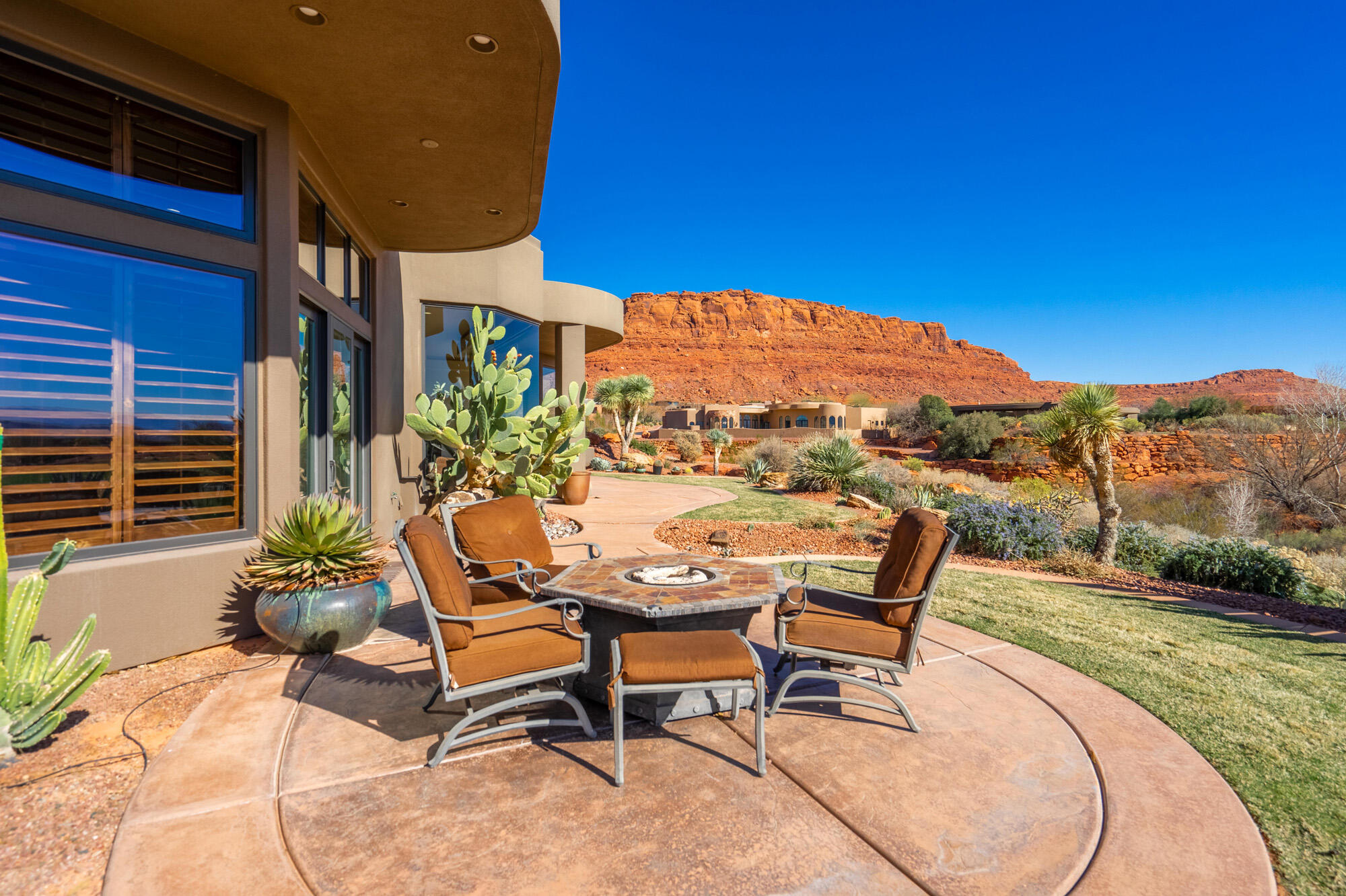 This is definitely a WOW home with STUNNING VIEWS of two fairways on the famous Entrada Golf Course! This home also boasts views of red rocks and Kachina Cliffs, Arizona Strip, Virgin River Gorge, and the western mountains from the main living area, dining area and kitchen, and master suite. Watch the shadows change on Red Mountain spanning around to Johnson Arch and the Scout Caves from the beautiful front courtyard. Amazing glass and wood front doors add to the luxury living and tasteful finishes of the home. As you enter, you will encounter those grand views again and the beauty of the main living area, stacked stone fireplace and entertainment center. The master suite also has floor to ceiling, wood clad, glass windows to enjoy the golf course and red rock views! Enjoy the ambience of stacked stone fireplace in master suite and wonderful master closet with access from garage to master bath and suite. Large master closet, too! The master bath has beautiful granite, large jetted tub and separate triple head shower to enjoy. The guest suites also enjoy privacy and access to the full bath on the east side of the home - separate from the main living area and master. WOW again on the executive office with wood floors and built-in book/trophy shelves with granite tops on lower cabinets. A closet has a safe, which is included in the price of the home. This area could be a wonderful craft room, too. The garage is extra deep and wide - plenty of room for toys and golf cart, along with 3 cars. FURNITURE INCLUDED. YOU HAVE TO EXPERIENCE THIS HOME AND VIEWS!

Residents enjoy low HOA fees, which include access to a pool, tennis courts, and front yard maintenance.

For those who join the Entrada Country Club, a variety of clubs and activities await, including pickle ball, tennis, swimming, yoga, and Pilates. Whether you're seeking outdoor adventures like hiking or exploring the area's breathtaking beauty, or simply wish to savor a meal at the on-site restaurant, Entrada offers something for everyone. It's a community where you can easily forge new friendships and create lasting memories. All property owners in The Cliffs of Entrada have the option to join the country club, which involves a monthly fee and an annual $800 food expense at the restaurant. Please note that golf membership is available at an additional cost.