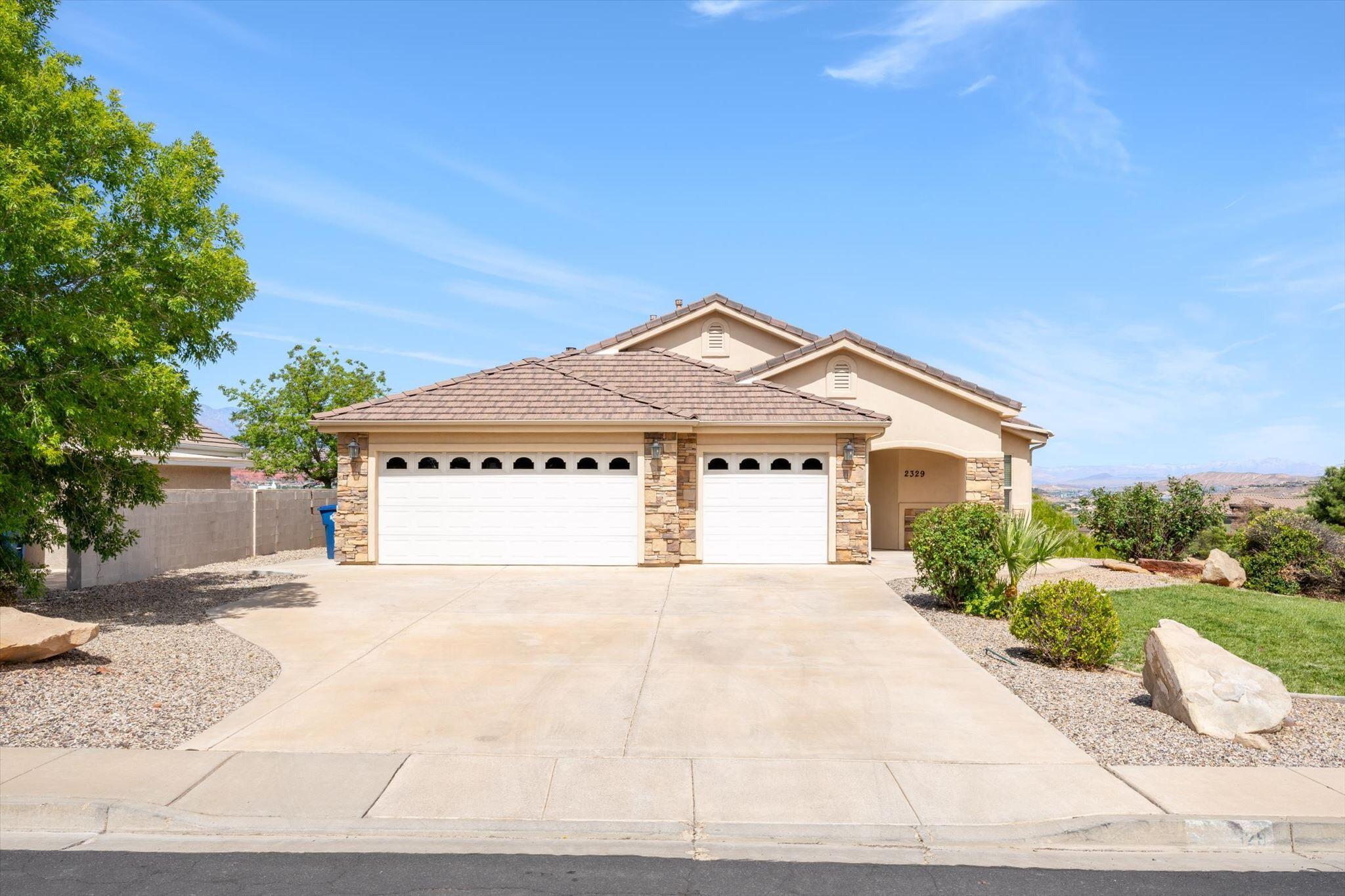 Perched in the desirable Verde Ridge community, this spacious 5 bedroom, 3 bathroom home offers room to spread out, a walk-out basement, and views that deserve their own standing ovation.

Step inside to soaring ceilings, abundant natural light, and an inviting open-concept layout designed for both everyday living and entertaining. The spacious great room features a beautiful stone fireplace and flows seamlessly into the kitchen and dining area, where granite countertops, stainless steel appliances, generous cabinetry, and a functional island create a space that's as practical as it is welcoming. Large windows frame stunning valley and mountain views, while the elevated deck is the perfect place to enjoy morning coffee or unforgettable Southern Utah sunsets.

The main-level primary suite offers a peaceful retreat with large windows, a spa-like en suite featuring a soaking tub, oversized walk-in shower, dual vanities, and a spacious walk-in closet with custom built-ins. Two additional bedrooms and a full bathroom on the main level provide flexibility for guests, family, or a home office.

Downstairs, the walk-out basement expands your living space with a large family room, two additional bedrooms, a full bathroom, a separate den, and extra under-the-stairs storage. Whether you need space for guests, hobbies, a home gym, or multi-generational living, this lower level delivers endless possibilities.

Complete with a 3-car garage, mature landscaping, and located in one of St. George's sought-after neighborhoods, this home checks all the boxes. And yes... the sunsets here may ruin every other view for you.