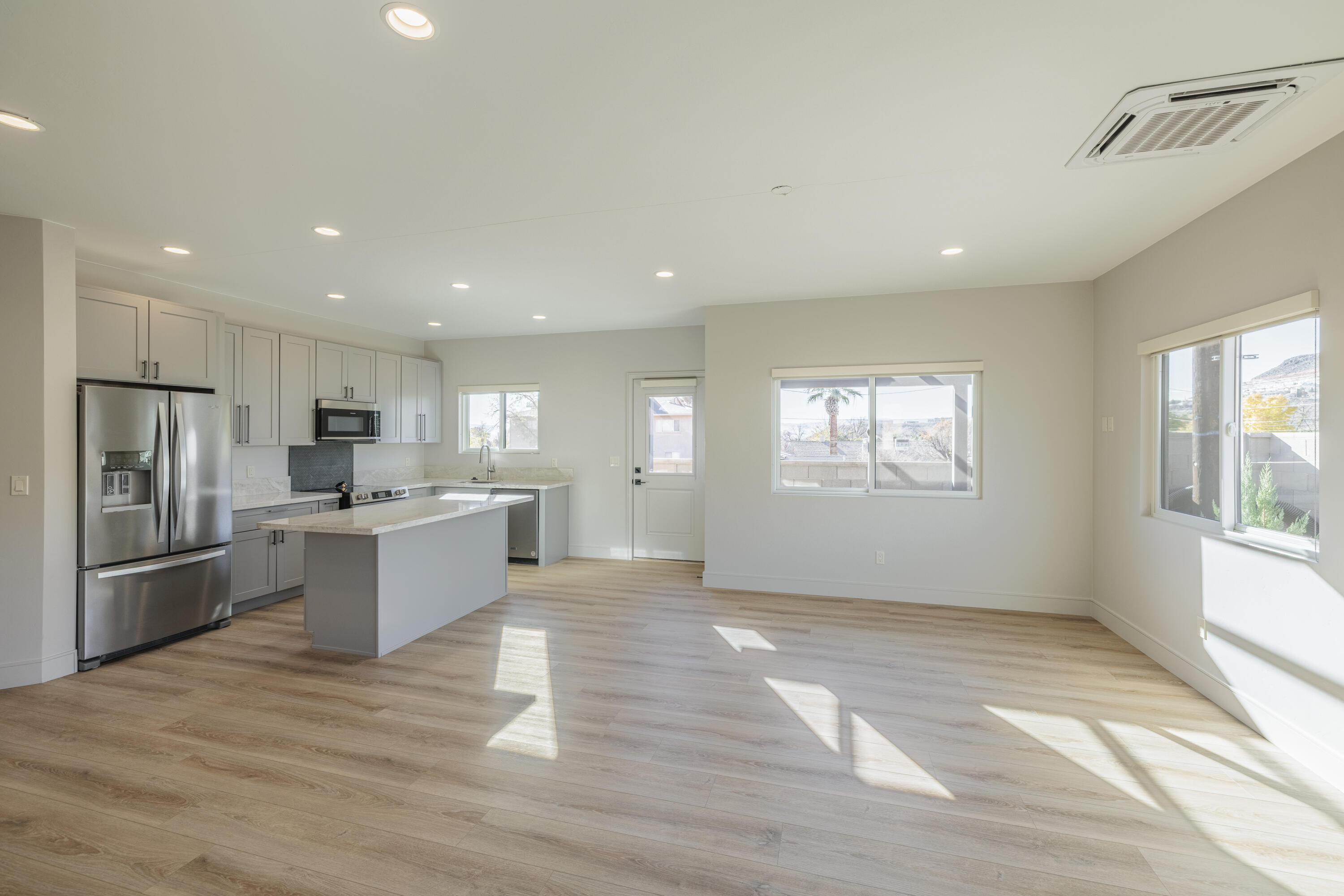 This beautiful, brand new home is situated on a 1/5th acre lot  in the heart of the vibrant city of St. George with easy access to all services, including dining, entertainment, retail and healthcare.  The home has 2,634 square feet with 3 bedrooms and 3 bathrooms, including an ADU unit that is ideal for a mother-in-law suite; a rental property; or a private space for adult children.  2 fully equipped kitchens (refrigerators, dishwashers, ranges, sinks) and 2 laundry rooms make this the ideal home for extended families or to collect rental income to help defray a monthly mortgage payment.  Luxury vinyl plank flooring throughout, granite countertops, lots of natural light, generous closets and storage spaces,  2 car garage and small fenced in yard perfect for family. Come see 313 for yourself.  Enjoy city living at its finest.