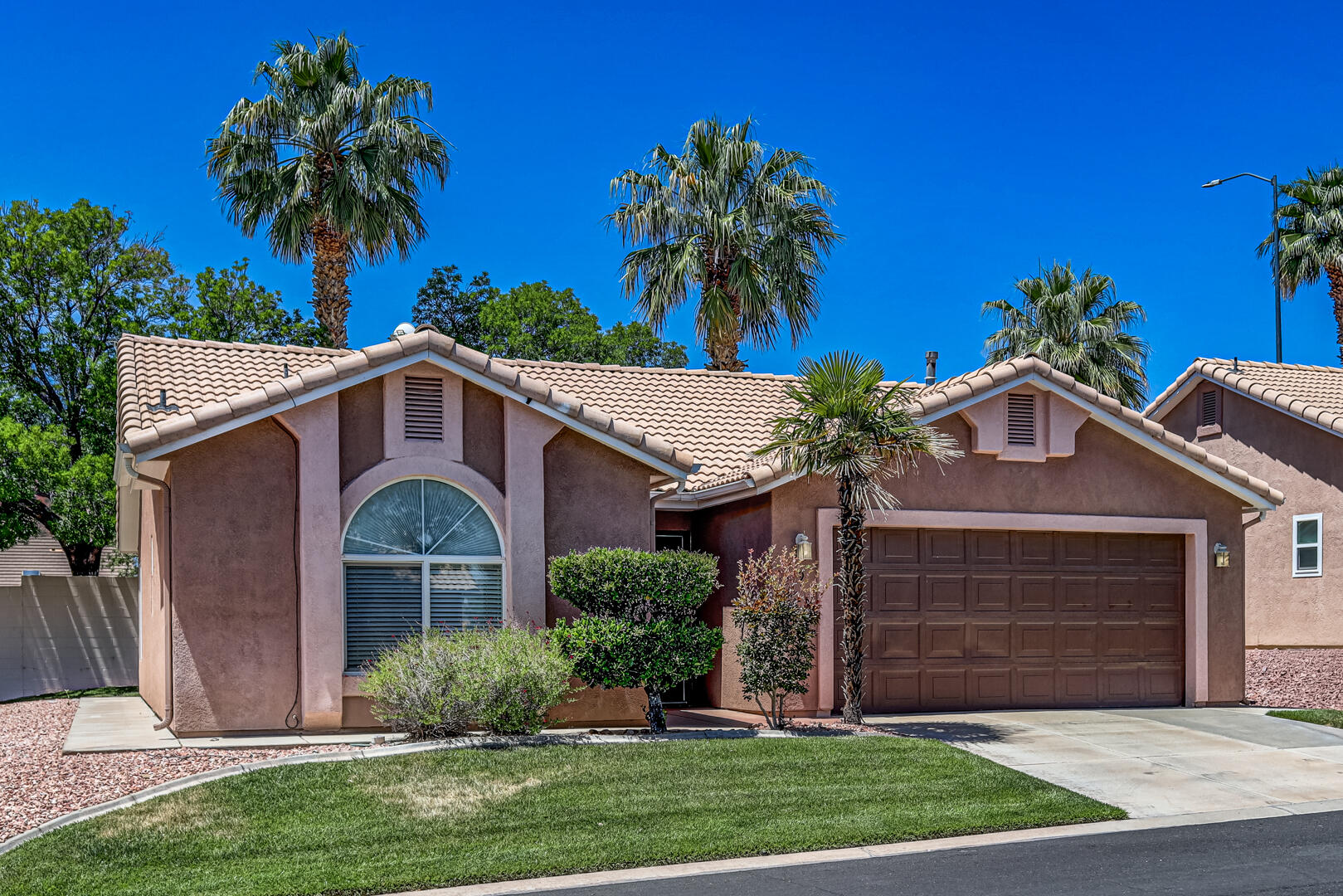 Welcome to the highly sought-after 55+ community of Santa Fe at Red Cliffs! This fully refreshed, freestanding townhome offers light, bright, and easy living in one of the area's most convenient locations. Thoughtfully updated with new LVP flooring, new carpet, and fresh paint throughout, this move-in ready home also features a newer HVAC system and water softener for added comfort and peace of mind.
The inviting open floorplan lives larger than its 1,138 sq. ft., with 2 spacious bedrooms and 2 bathrooms thoughtfully separated by a welcoming great room for privacy and functionality. The large 2-car garage provides ample storage, while the spacious covered patio is perfect for relaxing or entertaining in this quiet and friendly neighborhood.
Ideally located on Mall Drive with quick access to shopping, restaurants, entertainment, medical services, and I-15, this home combines convenience with low-maintenance living. Residents enjoy a beautifully updated clubhouse, indoor pool and jacuzzi for year-round enjoyment, and HOA-provided full yard maintenance for truly stress-free living.