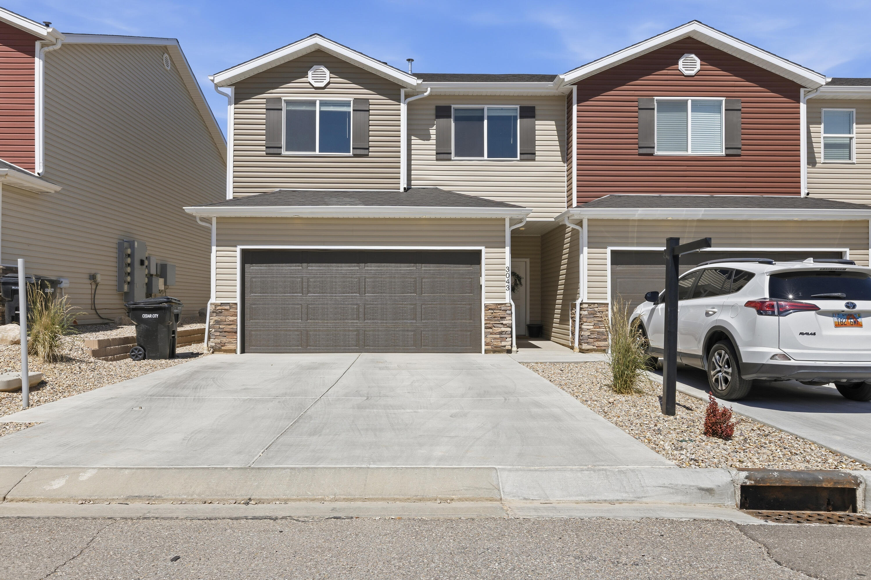 Near I-15 access • 2-car garage • Fenced backyard with covered patio. Built in 2024, this 3-bedroom, 2.5-bath townhome offers approximately 1,420 SF of living space with an open-concept layout. Kitchen features quartz countertops, stainless steel appliances, gas range, subway tile backsplash, and soft-close cabinetry. Living area includes a shiplap accent wall and updated lighting. Primary suite includes dual sinks and ample storage. Fenced backyard with covered patio provides additional outdoor living space. End-unit location offers added privacy and natural light. Approximately 2.8 miles to Cedar City Hospital and convenient access to shopping, dining, recreation, and regional travel routes. Ideal lock-and-leave ownership opportunity. Includes attached 2-car garage.