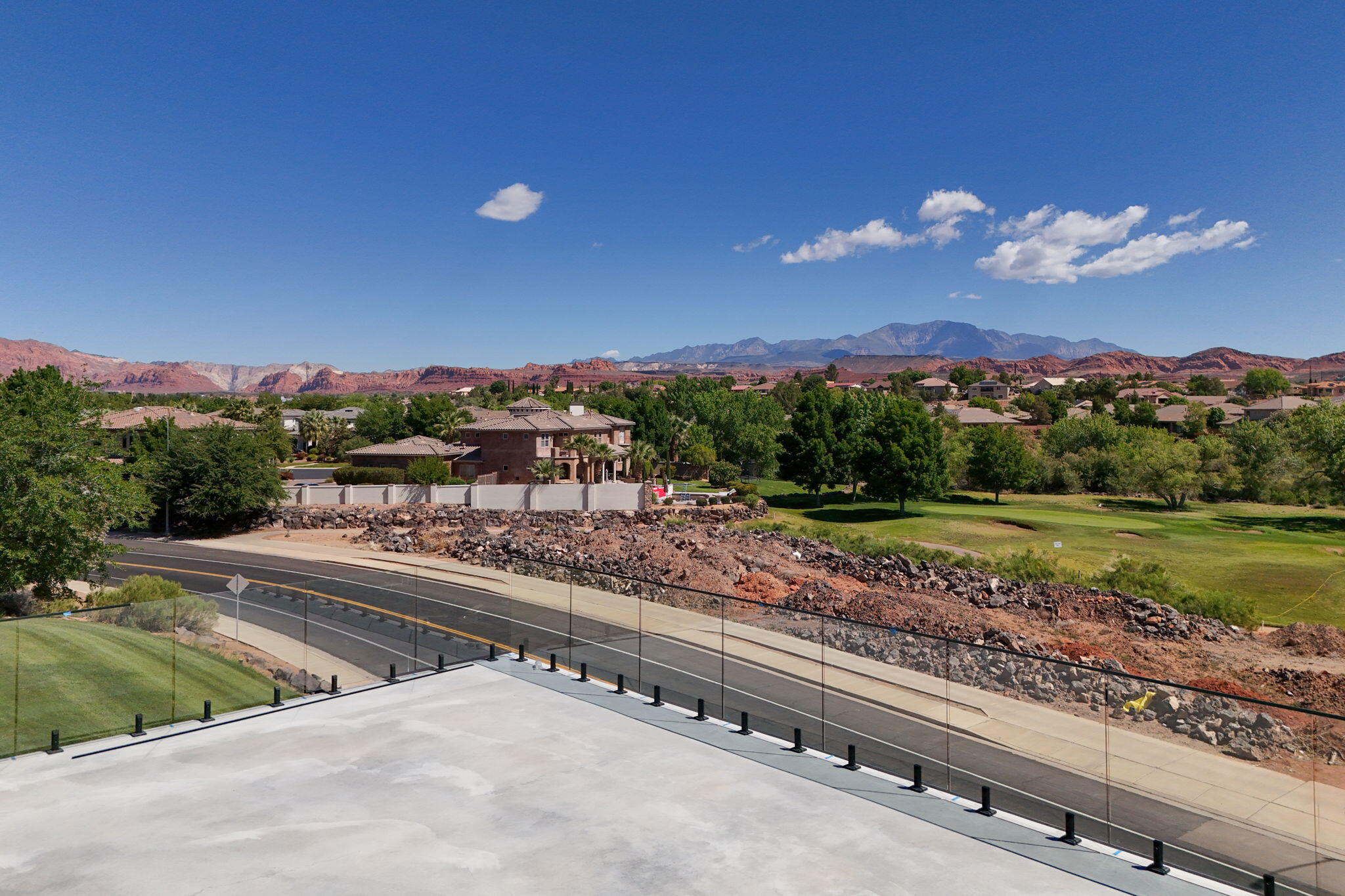 Some condos offer a view. This one offers a perspective. Positioned directly on the Sunbrook Golf Course, this brand new flagship unit represents the absolute pinnacle of luxury condo living in Saint George -- a city that has quietly become one of the most coveted destinations in the American Southwest. With unobstructed, panoramic views of Snow Canyon State Park and the Pine Valley Mountains stretching endlessly before you, this is not simply a place to stay. It is a permanent front-row seat to one of nature's greatest shows.

Step inside and the level of craftsmanship is immediately unmistakable. The expanded floor plan flows with an ease and generosity rarely found in condo living -- every surface, every fixture, every detail selected with intention. The gourmet kitchen is a chef's dream: premium appliances, designer cabinetry, and the kind of counter space that makes entertaining feel effortless. Three full bathrooms ensure every guest experiences the same luxury standard, while the primary suite is a sanctuary unto itself -- a spa-inspired bath that transforms your morning routine into a ritual.

'Step out onto your massive private patio, pour a drink, and watch the sun set fire to Snow Canyon's red rock cliffs. There is no finer seat in Saint George -- and it's yours every night.'
But the true showpiece of this unit is the massive private patio. Overlooking the Sunbrook fairways with Snow Canyon and Pine Valley as your uninterrupted backdrop, this outdoor living space is an entertainer's paradise -- complete with an outdoor kitchen that makes al fresco dining the only sensible choice every evening. Whether you're hosting a sunset gathering or sitting in quiet solitude with your morning coffee as the canyon glows at dawn, this patio will become the heart of your life here.