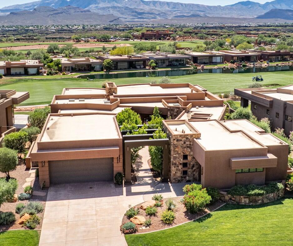 Nestled within the exclusive Entrada community, this custom masterpiece commands sweeping, unobstructed views of the golf course and the iconic red mountains. From the moment you pass beneath the dramatic arched entry framed in hand-laid stone and surrounded by lush, manicured desert landscaping, it is clear this home was designed to inspire. Inside, the great room showcases soaring tray ceilings, a floor-to-ceiling stacked stone fireplace, and wall-to-wall glass that dissolves the boundary between interior and the stunning panoramic views. The kitchen proudly presents rich alder cabinetry with raised panel detail, exposed wood beam ceilings with an arched accent, granite countertops, a generous curved island and professional appliances. The primary suite is wrapped in curved walls of glass framing the views of the fairway and mountains. The fully finished basement takes entertaining to another level, featuring a billiard room, media lounge, and stunning kiva-style fireplace. Notice the full casita with its own bedroom, kitchenette, laundry hookups, bathroom, private entrance, and views of the courtyard garden. Residents of Kachina Springs East enjoy the full spectrum of Entrada's world-class amenities. Access to the Entrada at Snow Canyon Country Club, tennis and pickleball courts, heated pools and spa, fitness center, and miles of trails winding through one of Utah's most spectacular natural settings. Kachina Springs East: $163 (master dues for road, gate, common areas) + $381 for patio with water homes = $544 
(they have to be associate members too, grand total = $784/month)

Mandatory associate membershipd dues: $240.00/month, these are in ADDITION to the HOA dues (gives you access to fitness center, pools, restuarant etc) andis calculated in paragraph above.

You can purchase an Equity Membership which then gives you golf privileges as well. Those are currently $125k to buy into it and the dues are $1,250.00 per month.
There is no reinvestment fee, but there is a $300 set up fee for all new owners.
Annual food expense is $850/year at the restaurant.