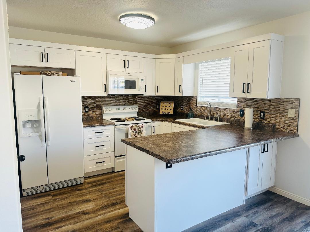 Beautiful fully renovated 3 bedroom 3 bathroom townhome. Upgrades include luxury laminate in kitchen, living room and bathrooms. New cabinets, new countertops, new paint, new light fixtures, new slider blind and new carpet in all but one room. Brand new HVAC system! All appliances included. Master bedroom has a gorgeous view of the pool! Family friendly environment and centrally located just off Dixie Drive in St. George.
