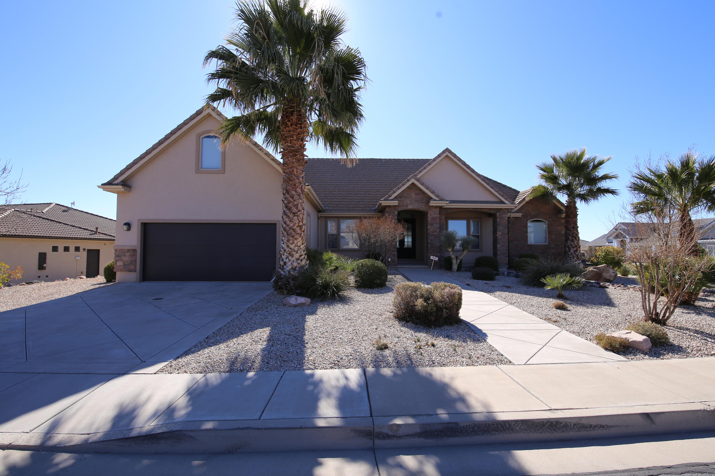 Spacious 7-Bedroom Home with Stunning Views in St. George, Utah! Nestled on a scenic hillside in beautiful St. George, this expansive 7-bedroom, 5-bathroom home sits on a generous third-acre corner lot and offers breathtaking views. Designed for both comfort and functionality, this home features two possible kitchens, two fireplaces, a bonus room, and a fully remodeled basement—perfect for multi-generational living, rental potential, or extra entertainment space. The main level boasts an inviting living area with abundant natural light, a well-equipped kitchen, and spacious bedrooms. The basement has been completely renovated, offering modern finishes and a versatile layout.. With its prime location, upgraded interiors, and flexible living space.  this home is a rare find in St. George