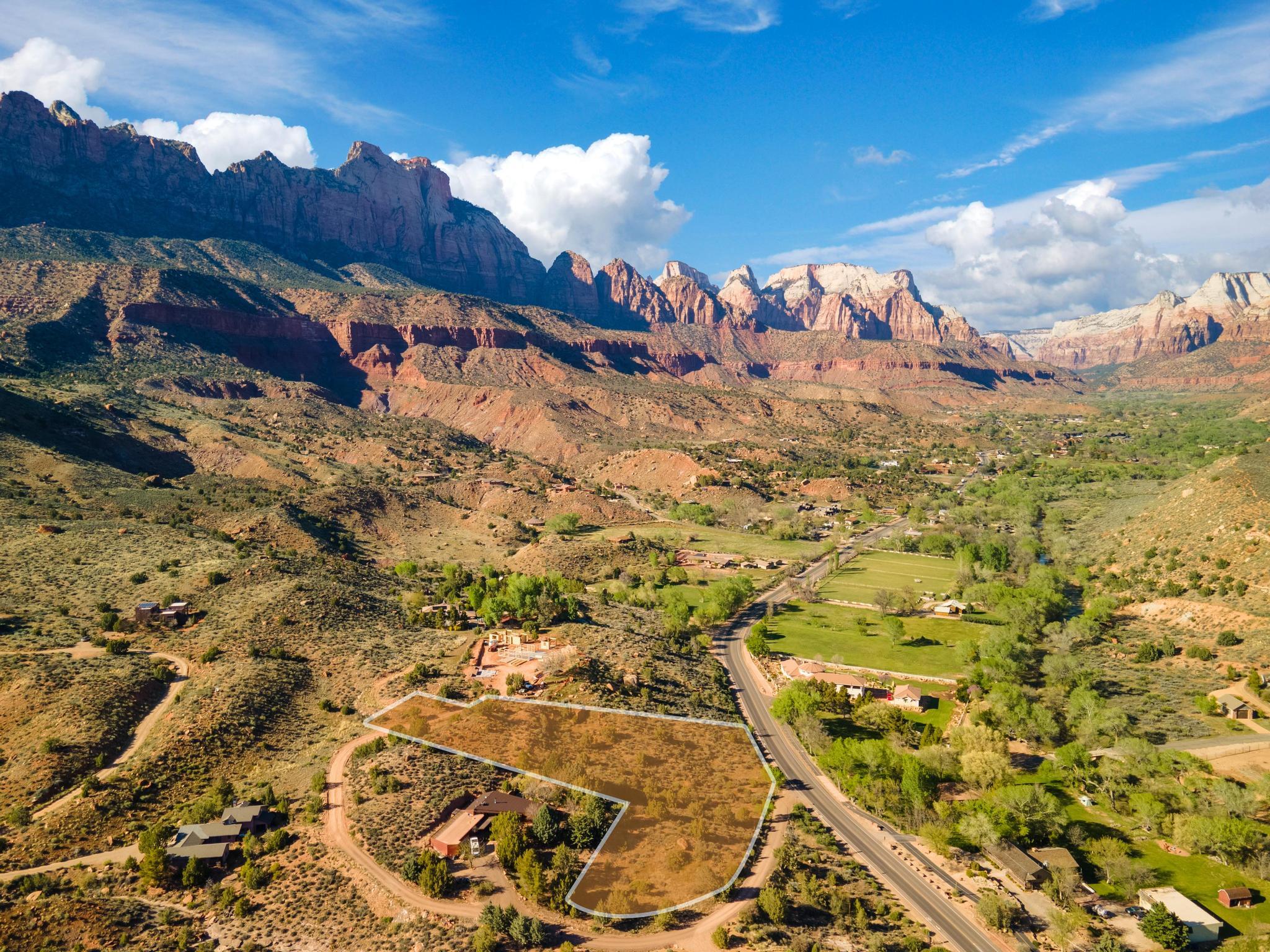 A Rare 2.1-Acre Legacy Homesite Overlooking Zion

Exceptional properties are becoming increasingly difficult to find in Springdale, and opportunities like this are truly limited. Just minutes from Zion National Park, this remarkable 2.1-acre homesite offers an extraordinary combination of privacy, space, accessibility, and some of the most breathtaking views in Southern Utah.

Situated on an elevated setting with commanding 360-degree panoramas, this property captures sweeping vistas of Zion Canyon, the Virgin River Valley, and Parunaweep Canyon. From sunrise illuminating the towering sandstone cliffs to spectacular sunsets painting the landscape in vibrant colors, every day feels like a masterpiece unfolding before your eyes.

Unlike many properties near Zion, this parcel provides the space and flexibility to create a truly custom retreat. Whether you envision a contemporary luxury residence, a mountain-modern getaway, or a timeless family estate, the setting offers a rare canvas for building a home that reflects your vision while embracing the surrounding natural beauty.

The location strikes an ideal balance between seclusion and convenience. Tucked away on a private road, you'll enjoy peace, quiet, and dark night skies, yet remain just moments from the Zion Canyon Shuttle, local dining, shopping, and endless outdoor recreation. Hiking, biking, photography, wildlife viewing, and year-round adventure begin right outside your door.

With utilities available along Kinesava Drive, much of the groundwork is already in place to help bring your dream home to life. Few remaining homesites offer this combination of acreage, accessibility, privacy, and iconic views in one of the most sought-after destinations in the Southwest.

This is more than a homesite--it is an opportunity to own a piece of one of America's most celebrated landscapes and create a legacy property to be enjoyed for generations.

Build where every day begins and ends with a view worth remembering.