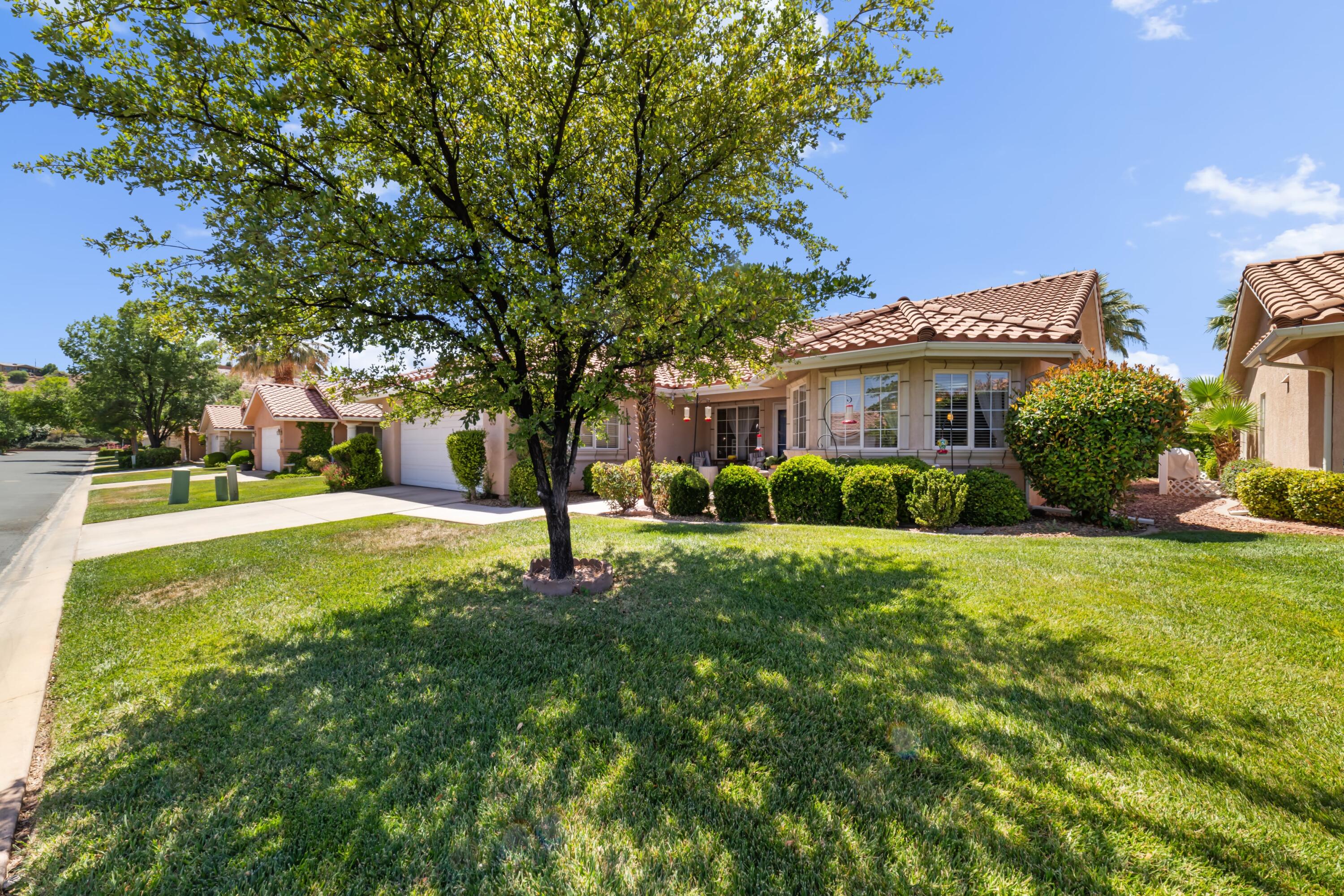 This beautiful and extremely well maintained home on a premium lot in The Villas is a perfect mix of serenity and opportunity. Within the community, you are located on the inner circle, away from the distractions and noise of the main roadway or industrial area. Upgrades include a remodeled kitchen with roller shelves, storm doors, new lvp flooring throughout the main living areas, and much more. Backyard access to the community's pool means cooling off in the St. George heat is only a few steps away, while a large hedge on the surrounding fence maintains your privacy. Located just across the roadway from Sunbrook Golf Course means enjoying the greens without the premium and risks of living in a course community. Only a short drive from grocery stores and other shops, you'll never find yourself feeling as if you live too far away from anything. A home like this won't last long, schedule your time to see it before it's too late!