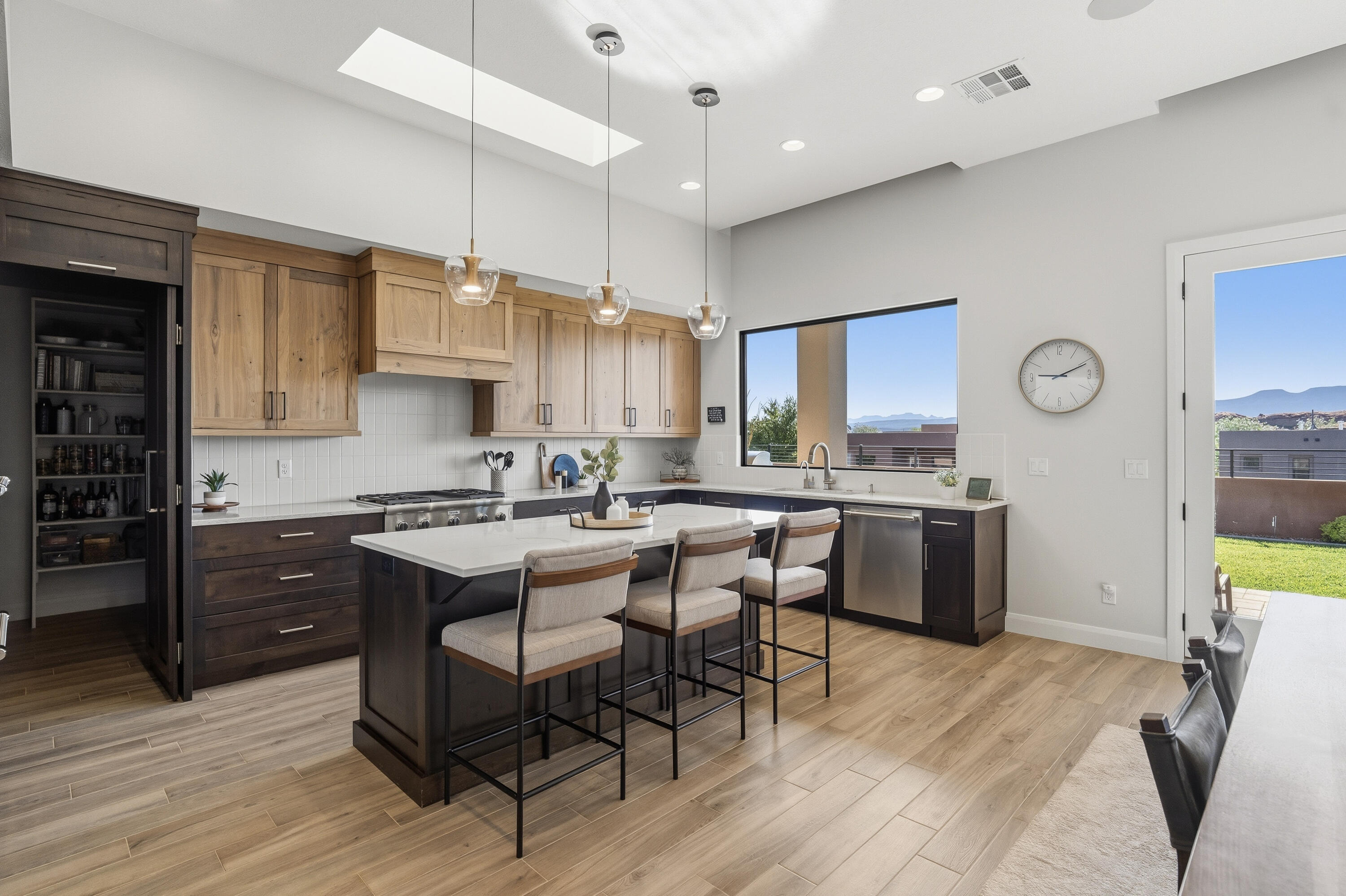 Nestled in Sand Hollow Resort, this custom Dennis Miller home is beyond amazing, offering every luxury upgrade you could ask for. From the custom cabinetry and elegant flooring to the oversized window above the kitchen sink that offers beautiful Red Rock Mountain views, every detail was thoughtfully designed to let you enjoy the outdoor scenery from inside. Enjoy electronic window shades, a stunning walk-in pantry with a coffee bar and wine cellar, upgraded Thermador appliances, an RO water system, a tankless water heater, a softener, Toto toilets, and a 3-zone heating/cooling system for ultimate comfort.

The home is filled with natural light thanks to bright solar lighting in the laundry room, bedroom closets, and hallway. Entertain effortlessly with the built-in BBQ with granite countertop, outdoor gas fire pit, built-in Jacuzzi, and deep covered patio designed for sun protection and year-round enjoyment.

The rooftop deck is truly spectacular, offering 360-degree views and gas, water, and lighting, with a classic covered staircase leading to the top--the perfect setting for entertaining guests or relaxing under the stars.

Additional features include full landscaping with timed sprinklers, security camera wiring throughout, solid custom wood doors, double-insulated walls and garage doors for extra sound protection and heat reduction. This quality home showcases craftsmanship in every corner.

This is luxury living at its finest.