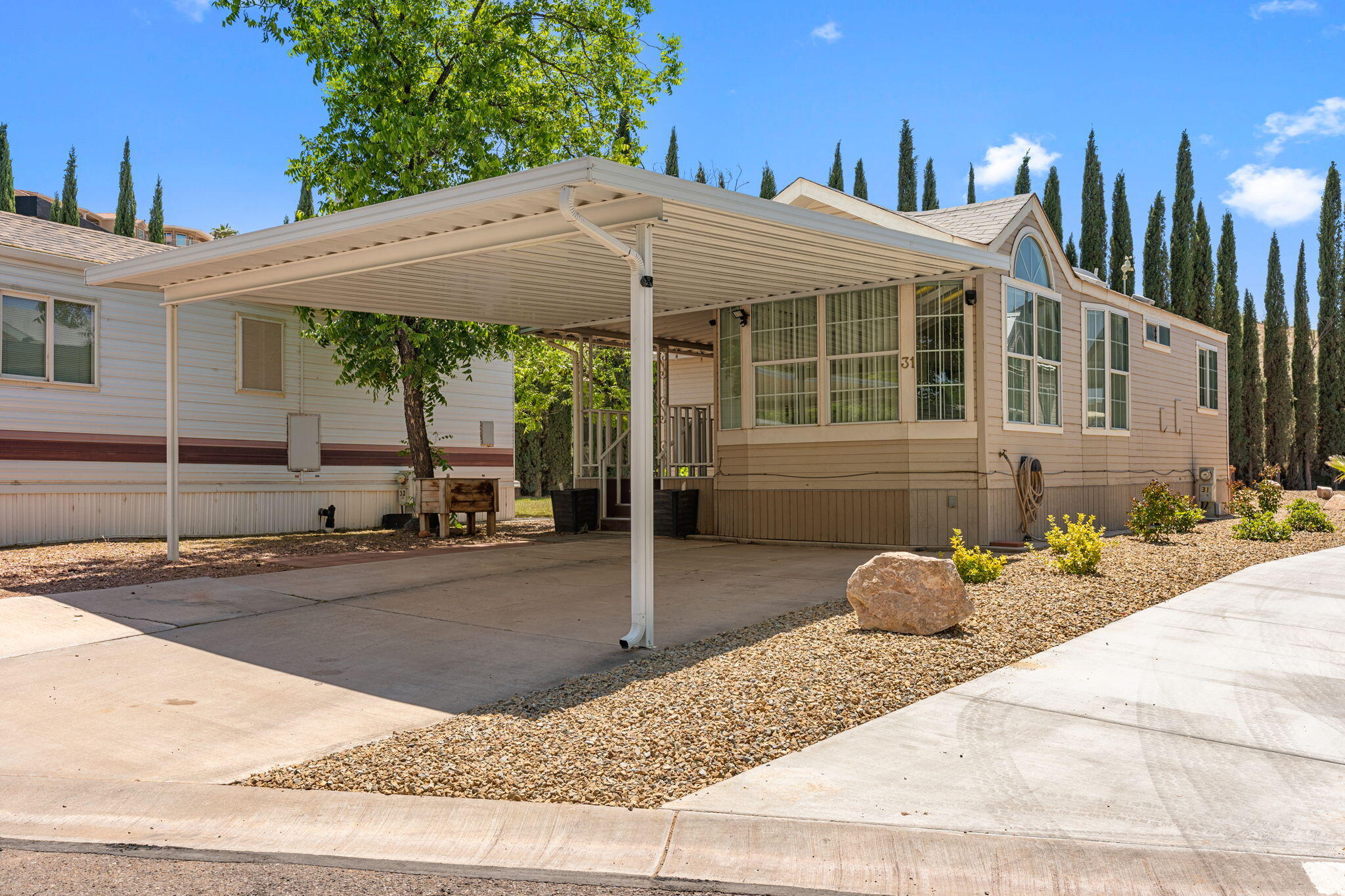 This home stands out from the rest with one of the largest lots in the community and features a huge barn-style shed offering multi-level storage space. Inside, you'll find newer flooring through the main living area and kitchen, plus a Murphy bed that makes the guest room feel extra functional. Located in a welcoming 55+ community with amenities including an indoor pool, hot tub, clubhouse, wood shop, and sewing room. A great opportunity for someone looking for both comfort and practicality without giving up space.