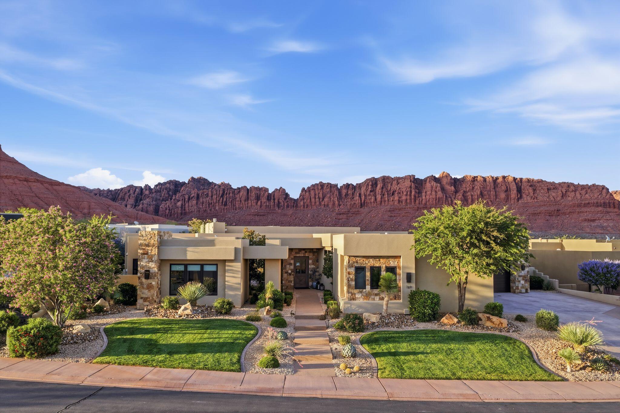 Experience unparalleled luxury in The Palisades at Snow Canyon. 
Nestled at the base of Red Mountain and Snow Canyon State Park, this stunning home embodies timeless elegance and sophistication.  With meticulous attention to detail, every aspect of this masterpiece shines, from the wide plank hardwood floors, to the exquisite  lighting, hardware, countertops, and rich cabinetry. Solid walnut doors add to the feeling of luxury as well as soaring 12 ft ceilings.
The piece de resistance is the seamless blend of indoor and outdoor living, thanks to large commercial-grade sliding doors that open up to a pool, hot tub, fire pit, outdoor built in BBQ, and breathtaking views of the surrounding red rock landscape. The .42 acre lot offers ample space to relax and entertain, while the split-floor plan provides privacy and comfort for guests. 
This extraordinary home features an oversized four car garage with epoxy flooring, a secret room perfect for an office, massage room, or kids play room. Relax and rest assured that your at home oasis will always be ready for you... with a recently installed home generator and a natural gas backup power source.  Enjoy smart home controls at your fingertips, managing lighting, temperature control, and your pool with ease... from home or from across the country. 
This is a home that cannot  be replicated, especially with this big, beautiful lot, and those fantastic views! Don't wait! This one is a show stopper!