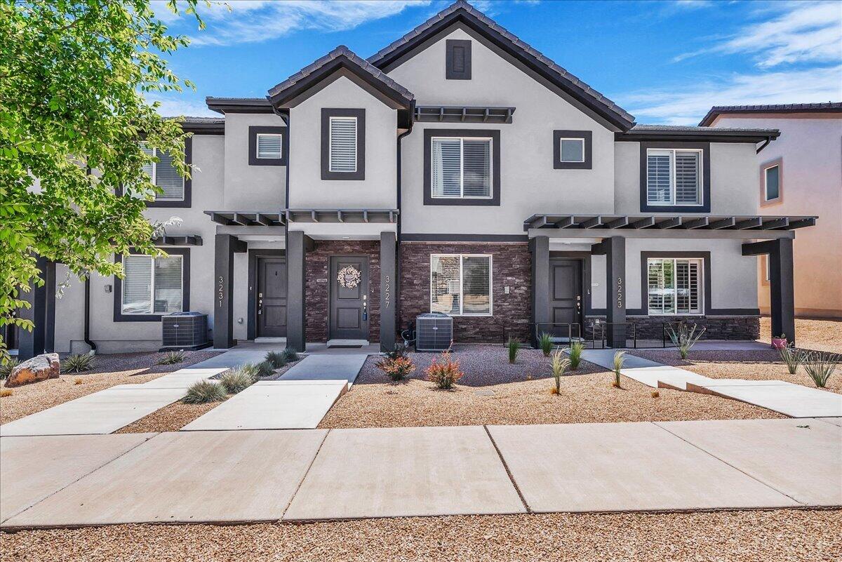 Enjoy low-maintenance living in this 3-bedroom, 2-bath townhome offering 1,315 sq ft and a 2-car garage. The interior features bright white cabinetry, stainless steel appliances, and an open, functional layout designed for everyday comfort. Located in the highly desirable Long Valley community, residents enjoy access to resort-style amenities including 2 pools, large hot tub, splash pad, 12 pickleball courts, basketball court, 18 hole mini golf course, driving nets, cornhole, large grassy areas with park, playground, and picnic areas, clubhouse banquet rooms, dog park, and walking trails. Photos of amenities are from the HOA website. Located 9 minutes from Sand Hollow - close to hiking, biking, boating, and more. Inclusions: Water softener, blinds, fans in all bedrooms, refrigerator, and the two mounted TVs.
