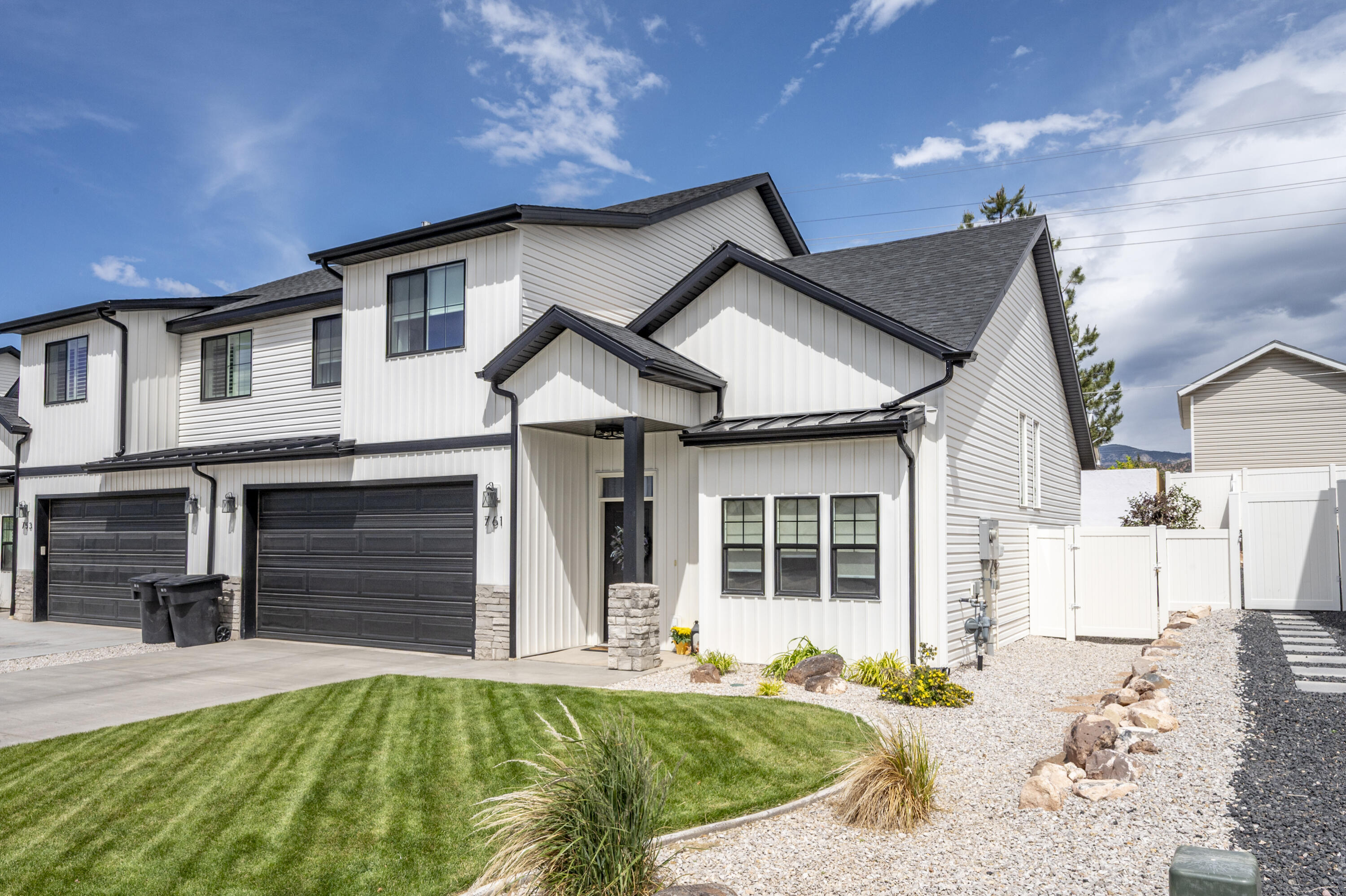 This twin home, built in 2023, offers modern living with thoughtful upgrades. Inside, you'll find Graber blinds and drapes throughout, along with premium quality carpet installed 18 months ago. The kitchen is equipped with a high-end dishwasher, gas stove, custom wall tile, and a sleek stove vent hood, making it a chef's delight. A soft water system ensures soft water in showers and sinks. The custom library is a standout feature with elegant French glass doors, opening into a space with built-in shelves for over 1,200 books, ideal for a private retreat. The living area includes a gas fireplace, adding warmth to the space. Outside, the well-maintained landscaped front yard and fully fenced backyard with a large patio offer great outdoor space and privacy.