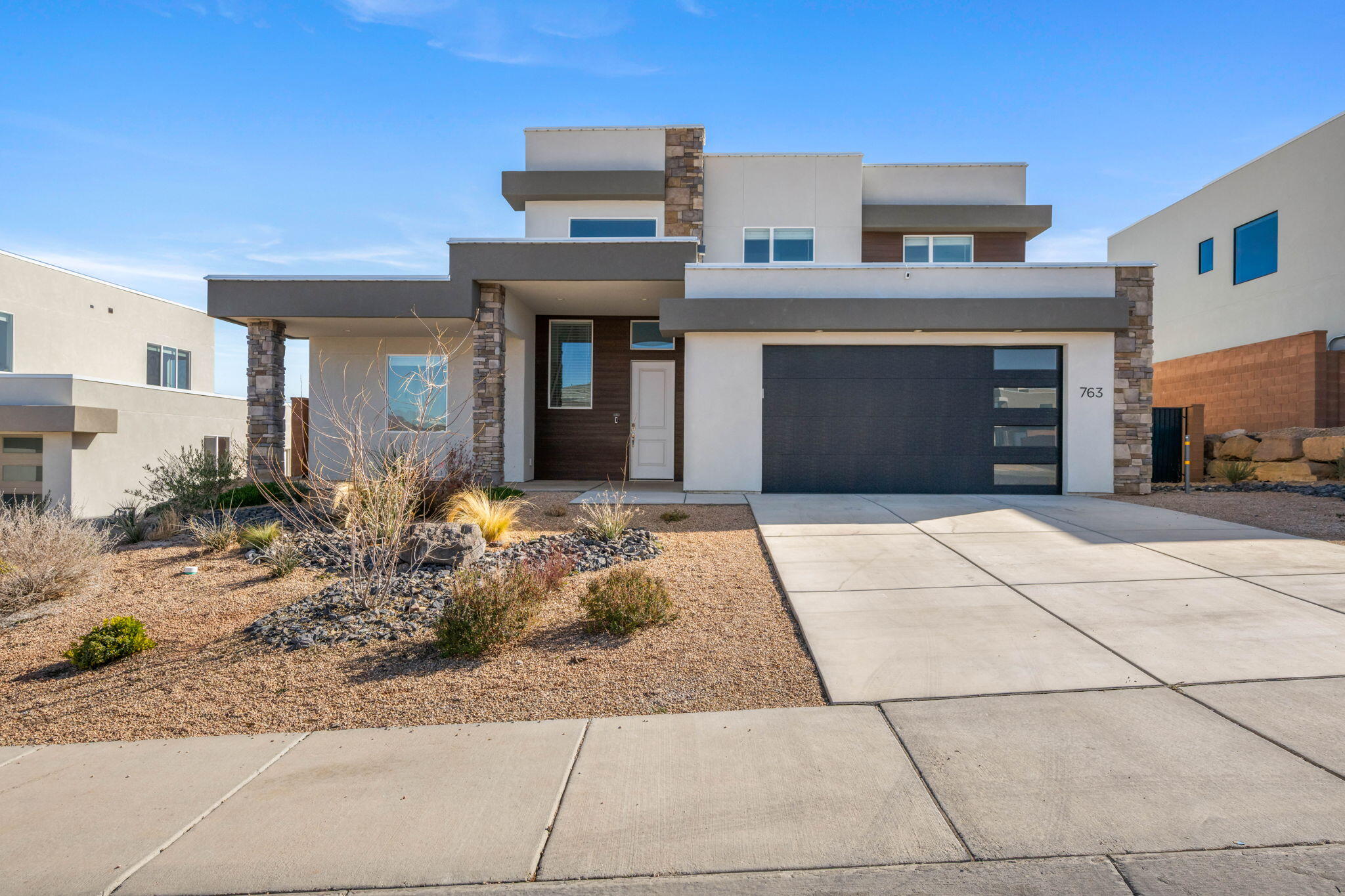 Welcome to this stunning two-story single-family home offering modern comfort, thoughtful upgrades, and resort-style outdoor living. The open-concept living space and kitchen create a bright, inviting atmosphere, enhanced by tinted windows and automated blinds in the living room and primary suite for added privacy and energy efficiency. The luxurious primary bathroom features a steam shower, while the home is equipped with an on-demand hot water heater and whole-home water softener for everyday convenience. Step outside to your fully fenced and gated backyard oasis, complete with a Trex deck surrounding a swim spa, a private putting green, and permanent exterior lighting-perfect for entertaining or relaxing year-round. This move-in-ready home blends smart design, modern amenities, and outdoor lifestyle in one exceptional package.