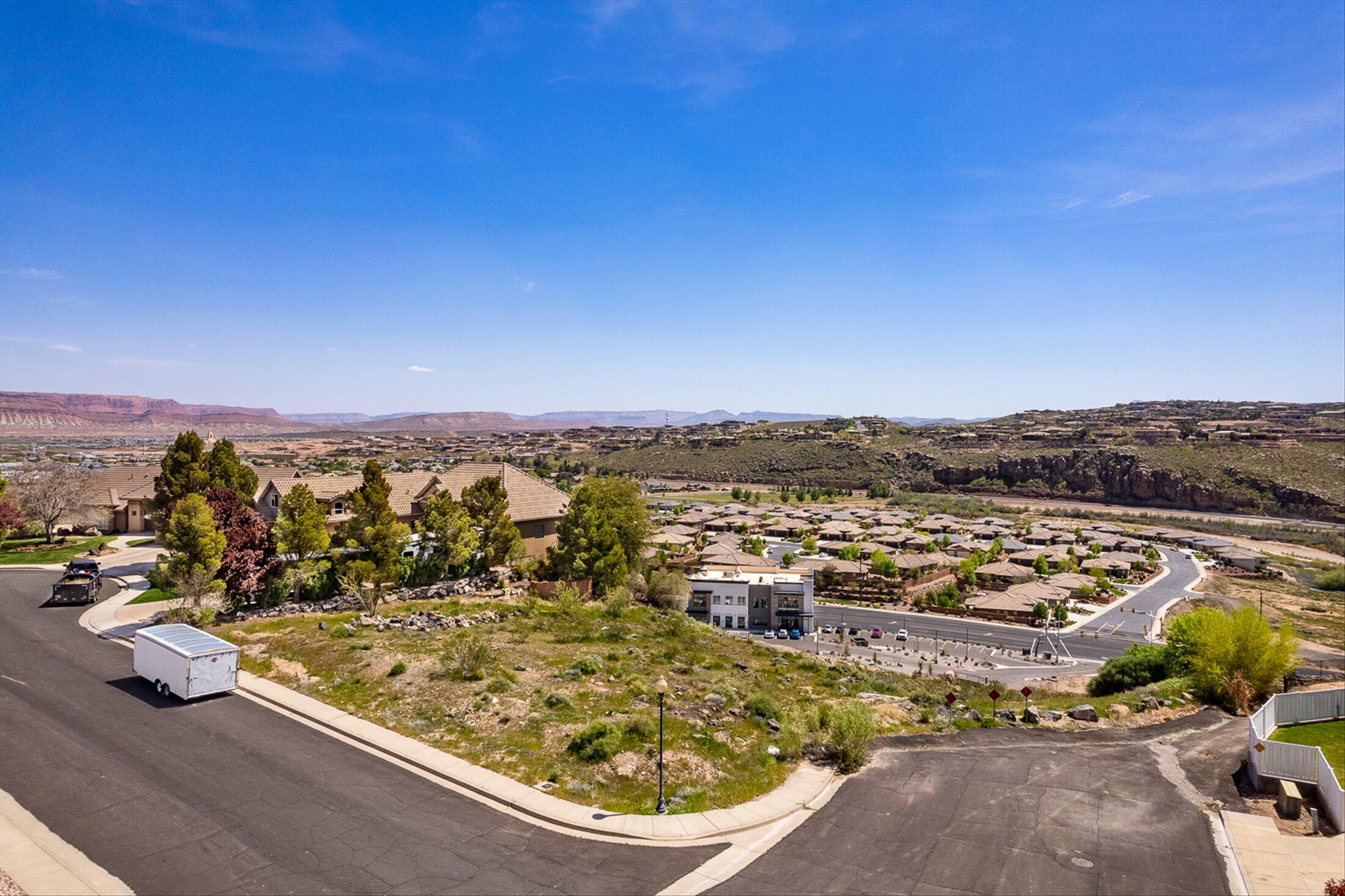 Build your dream home on one of the premier homesites in South Foremaster Ridge! This exceptional ½-acre elevated corner lot is ideally situated on a quiet cul-de-sac, offering breathtaking panoramic views of the surrounding mountains, valley, and Southern Utah's stunning red rock landscape. The gently sloping homesite provides the perfect setting for a custom residence designed to maximize both privacy and scenery. Enjoy the convenience of being just minutes from hospitals, shopping, dining, schools, parks, hiking and biking trails, while tucked away in one of St. George's most established and desirable neighborhoods. With ample space for a luxury home, expansive outdoor living, pool, RV garage, and more, this rare opportunity combines location, views, and lifestyle in one remarkable property. Bring your own builder and create the custom home you've always envisioned.