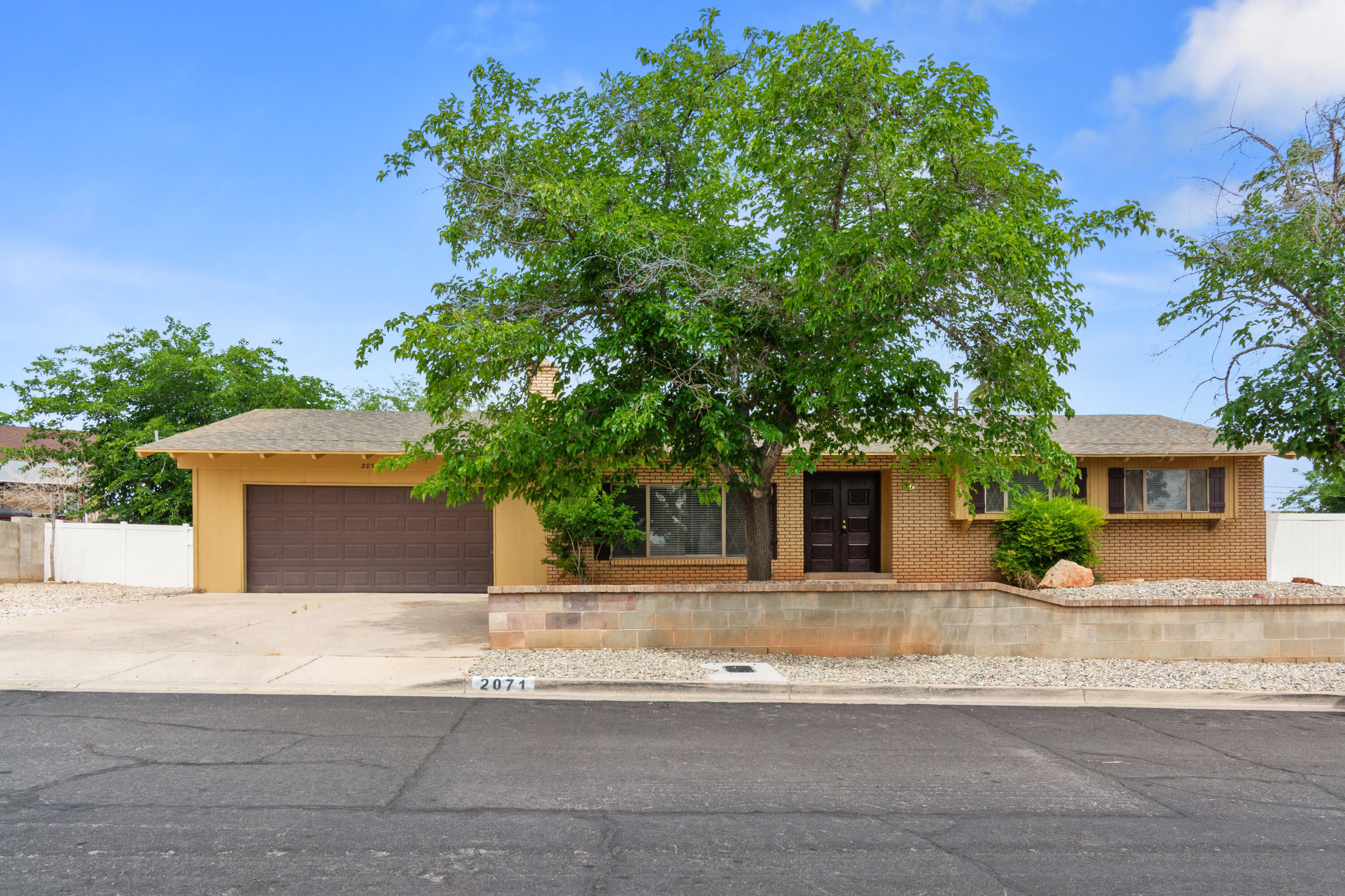 Welcome to your next home in the heart of St. George! This well maintained residence offers an excellent blend of classic charm and versatile living space. From the moment you arrive, the timeless brick-and-stone exterior and professional landscaping create a warm, inviting curb appeal. Inside, the main level is bathed in natural light, featuring a bright and airy layout with a functional kitchen with granite counter tops. The spacious primary suite provides a peaceful retreat, while the fully finished basement-complete with a second primary suite bedroom-offers incredible potential for a guest suite, home office, or multi-generational living. The excellence of this property extends outdoors to a private backyard oasis. Situated on a generous, fully fenced lot, the yard features mature trees, and a shaded patio perfect for weekend gatherings and outdoor entertaining. Located in a quiet, established neighborhood just minutes from local parks, shopping, and schools, this home combines space, comfort, and convenience. Don't miss the opportunity to make this versatile and charming property your own. Schedule a time to see it today!