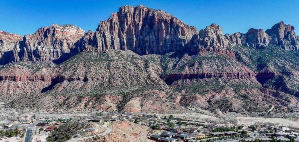 The Zion Retreat you've been looking for! Nestled in the tranquil Moenave community, just half a mile from the entrance of Zion National Park, this stunning home offers breathtaking, unobstructed views of The Watchman and West Temple mountains.
With expansive windows and 9' ceilings natural light fills every corner, ensuring you're surrounded by breathtaking scenery from every room.
The thoughtfully designed floor plan provides an inviting and spacious living area. The kitchen features a large island, granite countertops, subway tile backsplash, and custom cabinetry with crown molding, glass accents, and under-cabinet lighting. Stainless steel appliances, including a gas (propane) range and side-by-side refrigerator with water and ice dispenser, complete the space. The covered patio off the dining area creates a tranquil outdoor living space.
Luxury vinyl flooring flows throughout the main living areas, complemented by recessed lighting. Bathrooms feature tile flooring, tile shower surrounds with glass doors, and granite countertops, adding to the home's refined design. 
This home is like brand new, having only been stayed in for 2 or 3 weekends. All furnishings are available for purchase, making a seamless transition into your move-in-ready retreat.
Built with high-quality, energy-efficient features, including 2x6 exterior walls, blown-in insulation (R50 attic / R23-25 walls), Low-E windows, a 95+% efficient furnace, and a tankless water heater, this home offers both comfort and sustainability.
Located at the heart of Springdale, and in walking distance from its shops and restaurants with an abundance of stunning hiking and biking option, this home is the perfect blend of luxury, convenience, and breathtaking, natural beauty. Everything you dreamed your Zion Retreat would be, and more!
Springdale does not allow overnight rentals. Long term rentals are allowed at a minimum of 60 days. All information provided as a courtesy. Buyer to verify all.