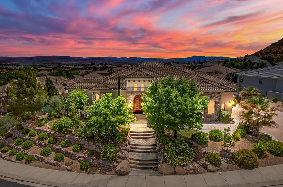 Some homes are simply built differently. Set on an elevated lot in the coveted Northbridge community of Green Springs, this 5,018 sq ft residence was designed for the way people actually live -- beautifully and without compromise. The main level delivers a serene primary retreat, a handsome office with custom built-ins & fireplace, and a gourmet kitchen appointed with cherry cabinetry, granite counters, pot-filler, prep sink & walk-in pantry. Three fireplaces, a wet bar, and a covered deck framed by mature palms set the tone for effortless entertaining. The walk-out lower level -- complete with a second kitchen, theater room & three additional bedrooms -- is ideal for multigenerational living, a private second-home escape, or an exceptional corporate retreat. Contact listing agent to schedule your private showing today. Outdoor Amenities: Heated spool (currently drained) with black pebble and abalone finish. Natural rock waterfall, tropical landscaping, and landscape lighting. Two covered patios, firepit area, raised garden beds, and a 5-hole putting course. Fully automated irrigation system for easy maintenance
Additional Highlights: Two garages (3-car total) with built-ins and attic access, 3rd garage has extra depth. Kenetico water conditioning system with RO, central vac, monitored security system. Three HVAC zones, two water heaters with recirculation pump, and extra insulation throughout. Custom window treatments, plantation shutters, and in-ceiling sound systems with room-by-room volume control. 

Location Perks: Minutes from schools, parks, shopping, and the new Washington Parkway for easy access to I-15. North Bridge Estates is known for its quiet luxury and elevated lifestyle.

A Home Built to Last. With timeless finishes and a layout designed for comfort, this property offers space, serenity, and lasting value. Private showings available now.