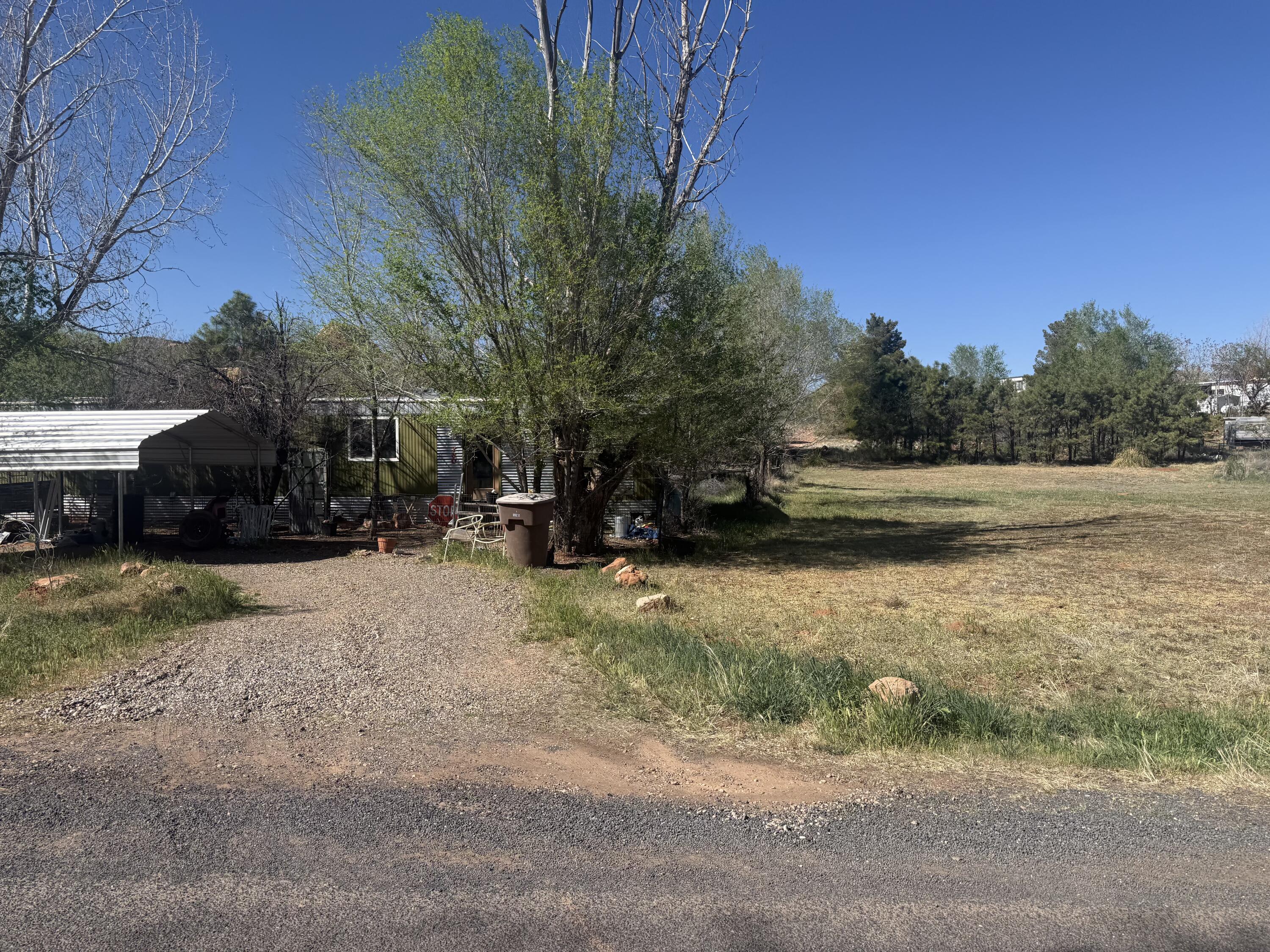 Discover the charm of Kanab in this 2-bedroom, 1-bath home offering 784 square feet of comfortable living space. Set on approximately one-third of an acre, the spacious lot features mature trees that add shade, character, and room to enjoy the outdoors. The home includes window A/C, an evaporative cooler for seasonal comfort, and a pellet stove for heating. Conveniently located near the heart of Kanab, the property is close to schools and ball fields, with easy access to local dining, shopping, and outdoor recreation. Enjoy proximity to many of Southern Utah's renowned destinations, including Best Friends Animal Sanctuary, Zion National Park, Bryce Canyon National Park, the Grand Canyon North Rim, Lake Powell, and Grand Staircase-Escalante National Monument. With its manageable footprint, generous lot, and convenient location, this property offers a great opportunity for a primary residence, second home, or investment property in one of Southern Utah's most scenic areas.