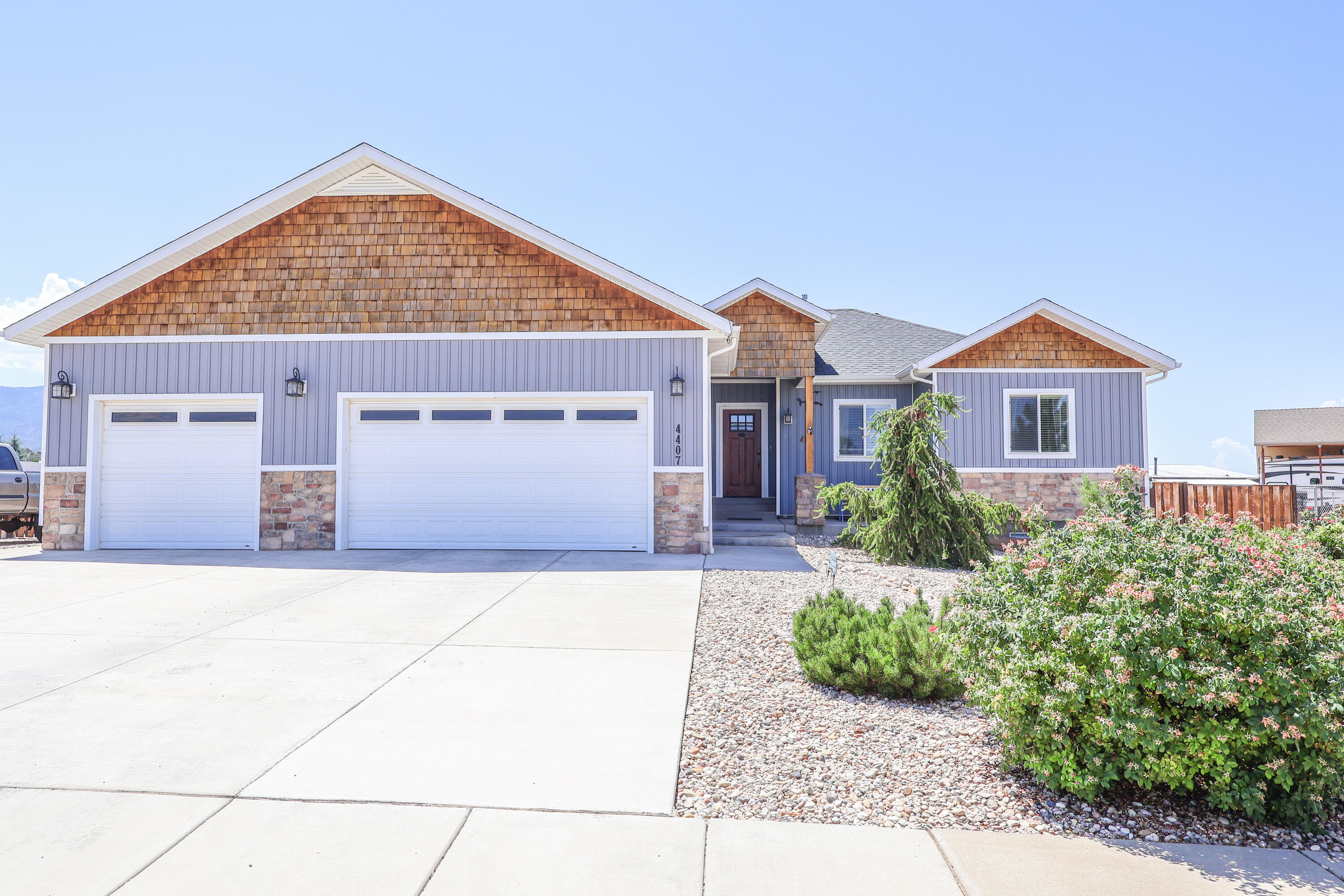 This home is made for entertaining, relaxing and enjoying the mountain views. The covered deck overlooks a spacious grassy backyard, while the third garage bay offers a rear pull-through door for convenient yard access.  Garage benches are included, and 220V outlets are available for a spa and RV use. Downstairs, the retro second kitchen, saloon-style gathering area, theater space, and storage room create a truly  unique place to host, unwind and make memories. Buyer to verify all information.