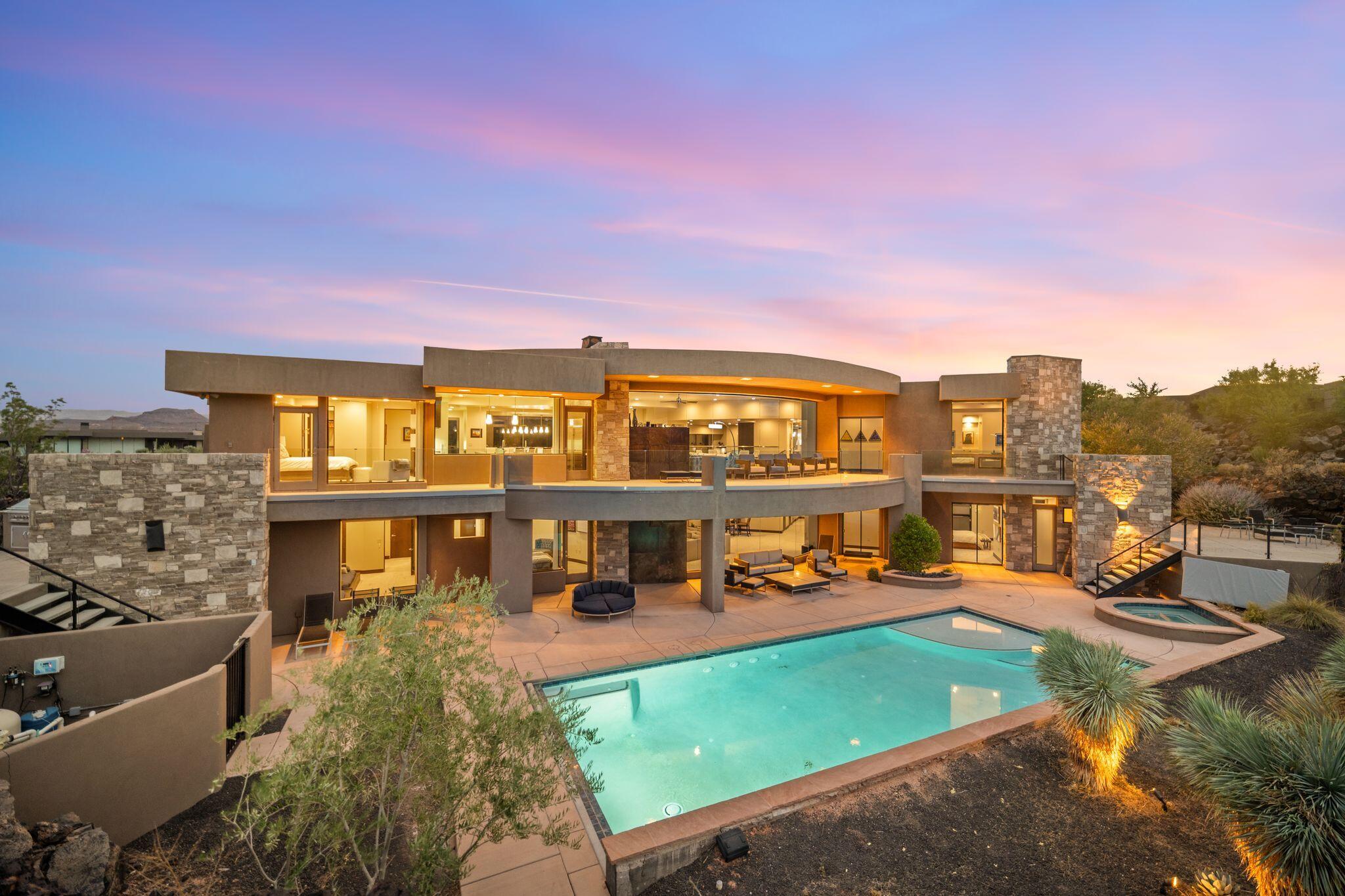 Welcome to your private desert sanctuary nestled in the heart of the prestigious Entrada at Snow Canyon Country Club. This one-of-a-kind estate sits on a rare 2-acre golf course lot and offers over 7,000 square feet of luxury living, designed to embrace the natural beauty of Southern Utah while delivering unparalleled comfort and sophistication.

From the moment you arrive, you're greeted with panoramic, unobstructed views of Snow Canyon, creating a truly breathtaking backdrop that seamlessly blends indoor and outdoor living. Thoughtfully positioned to maximize privacy and scenery, this architectural masterpiece boasts an open-concept layout, soaring ceilings, and walls of glass that invite natural light and red rock vistas into every room. The gourmet chef's kitchen is the heart of the home, outfitted with top-of-the-line Sub-Zero and Wolf appliances, custom cabinetry, and an oversized island perfect for entertaining. Flowing effortlessly from the kitchen is a spacious great room with a sleek fireplace and retractable glass walls that open to an expansive outdoor living area.

Step outside to your personal resort, featuring a custom-designed swimming pool, spa, outdoor kitchen, and shaded patiosall overlooking the golf course and framed by the awe-inspiring cliffs of Snow Canyon.

Inside, the home offers 5+ bedrooms, multiple en-suite baths, private office, and a state-of-the-art indoor basketball courta rare amenity that elevates this home into a league of its own. The expansive primary suite includes a spa-inspired bath, dual closets, and private terrace access with sunrise and sunset views that are nothing short of spectacular.

This is more than a homeit's a lifestyle. Located in the guard-gated Entrada community, residents enjoy exclusive access to championship golf, fine dining, fitness facilities, and the serene desert landscapes that make this region a world-class destination.

Schedule your private tour today and experience luxury living at its finest in Entrada @ Snow Canyon.