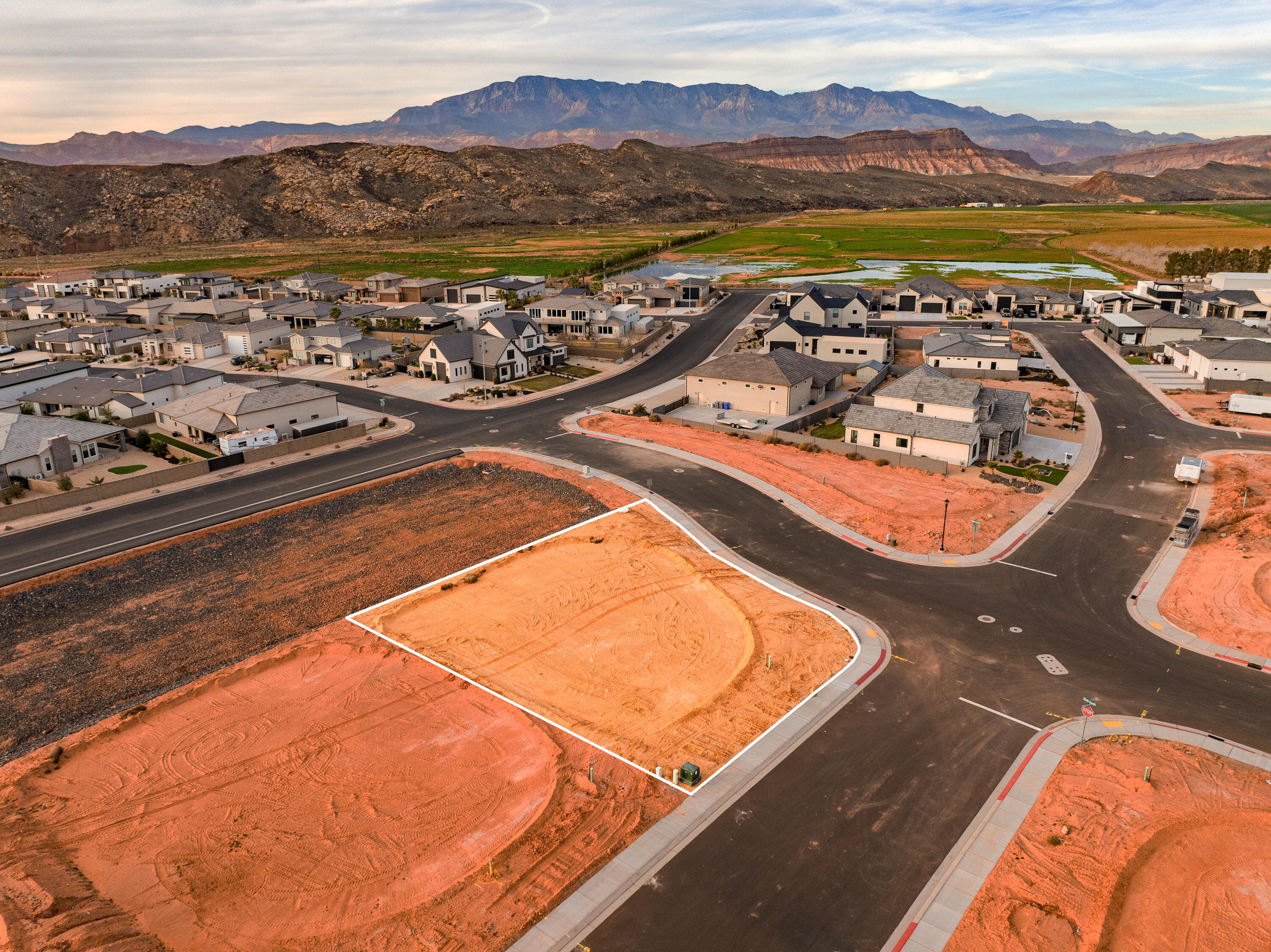 A short RZR ride from Sand Hollow Reservoir and the sand dunes, adventure starts at your garage door. Lot 45 is elevated above a storm water basin and offers a stunning unobstructed view! Build your home base for adventure in Phase 2 of Sand Hollow Village. This lot was made for people with toys—ideal for a modest home with a massive RV garage. Keep your camper, boat, side-by-side, Jeep, and motorcycles...all the gear...on site and skip the storage unit. A place to launch big weekends, unwind after long days outside, and settle in for the long haul—whether you're growing a family or easing into retirement. Friendly, clean neighborhood with sensible CC&Rs that protect quiet enjoyment. No snooty HOA. All builders welcome. Call for an introduction to a home builder.
