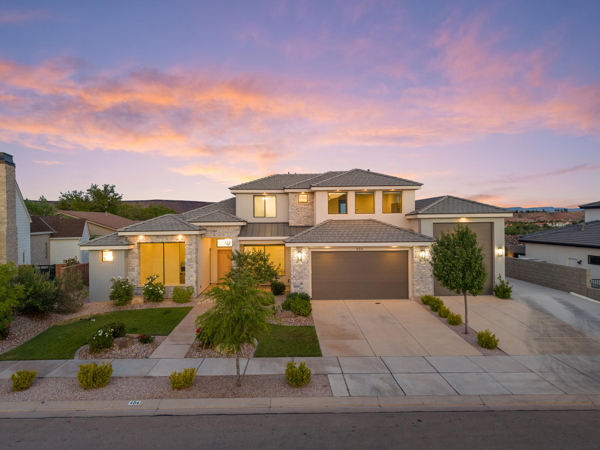 Luxury home in a highly sought-after St. George neighborhood with minimal traffic, yet close to everything! This spacious home features real wood floors throughout the entire first floor and soaring 10-12 ft ceilings, creating an open and elegant feel. The master suite includes a 6-foot soaking tub and a large walk-in closet, while the kitchen offers abundant cabinet space and a generous pantry. Perfect for guests or multi-generational living, the attached IADU / mother-in-law suite provides flexible space and potential income. The outdoor ''toy lover's'' RV garage, measuring 14 wide x 42 deep x 15 tall, and additional parking easily accommodate trucks, ATVs, boats, and more, with ample storage throughout the home.