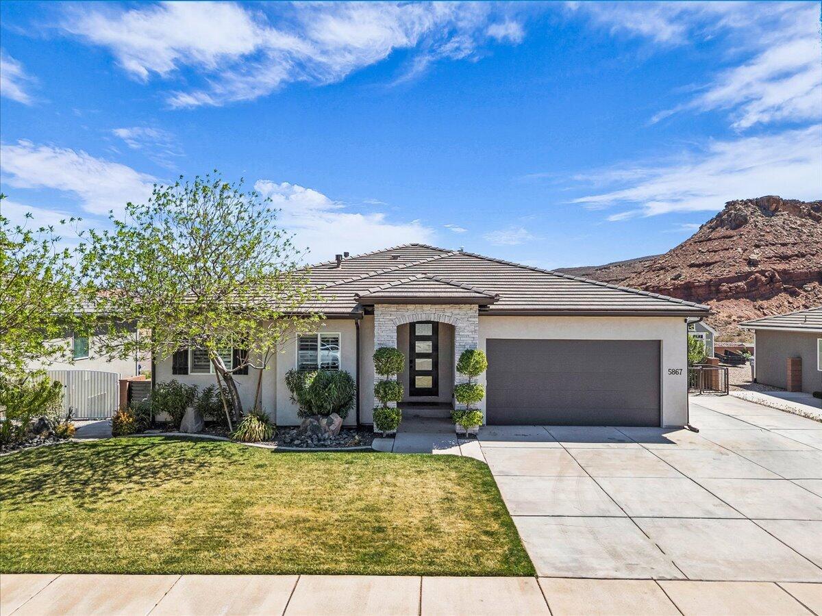 Motivated sellers! View lot with no HOA, panoramic backyard views, and a fully separate basement apartment that rented for $1,850/month.

The main level features a bright, open floor plan with 9-foot ceilings, quartz countertops, custom built-ins in the office and living room, custom window coverings, and abundant natural light. The main residence includes 3 bedrooms, 2 baths, an office, a second living room/playroom in the basement (wired for a future theater room), and a dedicated storage room. The upstairs is fully furnished, and all furniture is included with the sale.

The basement also houses a self-contained 2 bed / 2 bath accessory apartment with a full kitchen, private master suite, living room, and its own laundry room. It's currently sealed off from the main home for full privacy, but the connection can be reopened anytime. Ideal for multigenerational living, guests, or continued rental income!

Upgrades and systems include filtered drinking water, a whole-home soft water system, dual AC units, dual water heaters, and the entire home pre-wired for speakers. Both refrigerators and both washer/dryer sets included with the sale.

Outside, the entertainer's backyard delivers panoramic views, an in-ground trampoline, and a yard hydrant for easy watering. A gas line is already run for a future pool or hot tub. RV parking on-site.

Desert Canyons sits minutes from the St. George Regional Airport and 7-8 minutes via the Southern Parkway to I-15, putting the new Costco at Desert Color, Smith's Marketplace, the new Megaplex movie theater, and a growing lineup of restaurants and retail right at your doorstep.

Square footage figures are provided as a courtesy estimate only. Buyer is advised to obtain an independent measurement.

***Basement pictures to be added shortly!