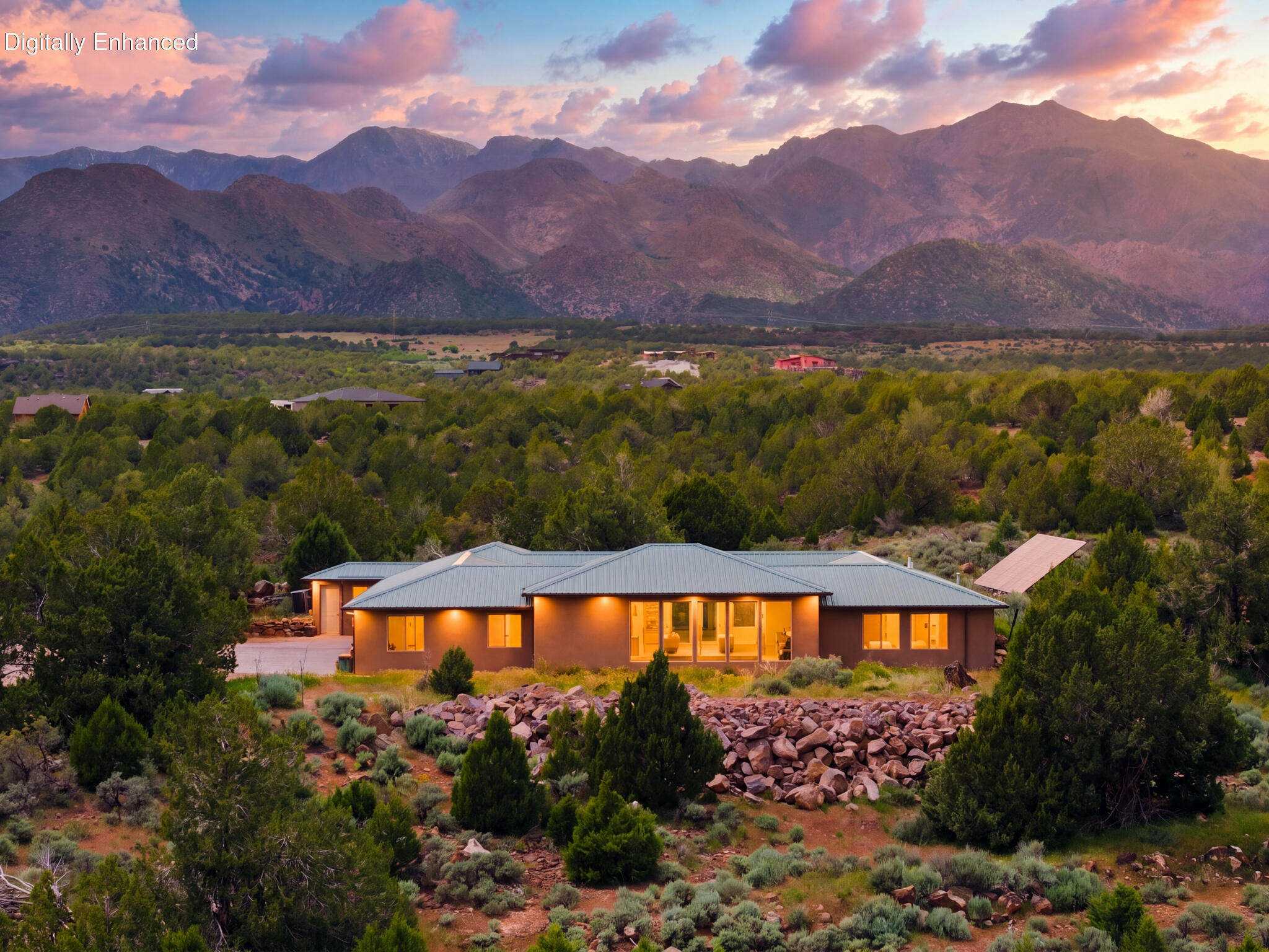 Escape to your own private retreat in New Harmony, Utah. Situated on 5 secluded acres with stunning mountain views, this one-of-a-kind property offers the perfect blend of privacy, comfort, and functionality. Natural light fills the home, centered around a unique enclosed courtyard that creates warmth and character throughout. Thoughtful craftsmanship shines with granite countertops, knotty alder doors, reclaimed elm wood accents, and durable polished concrete flooring.

Designed for flexibility and lifestyle, the property features a dedicated pottery room/hobby space/man cave, plus a separate casita/mother-in-law quarters--ideal for guests or multigenerational living. Several custom-built furniture pieces are seamlessly integrated, adding both charm and function.

Built with efficiency in mind, the home includes solar panels that generate enough power to offset electricity and contribute back to the grid, along with three on-demand water heaters. Average total utilities (electricity, gas, and water) are just $112/month. A reinforced storage room with concrete walls, ceiling, and floor adds exceptional utility and security.

Zoned for up to 4 horses and including 1 acre-foot of water rights, this property is ideal for those seeking space, self-sufficiency, and room to create. Enjoy mountain living with temperatures typically 10-15 degrees cooler than St. George, while still being within easy reach of both St. George and Cedar City. A rare opportunity to own a truly unique Southern Utah escape.