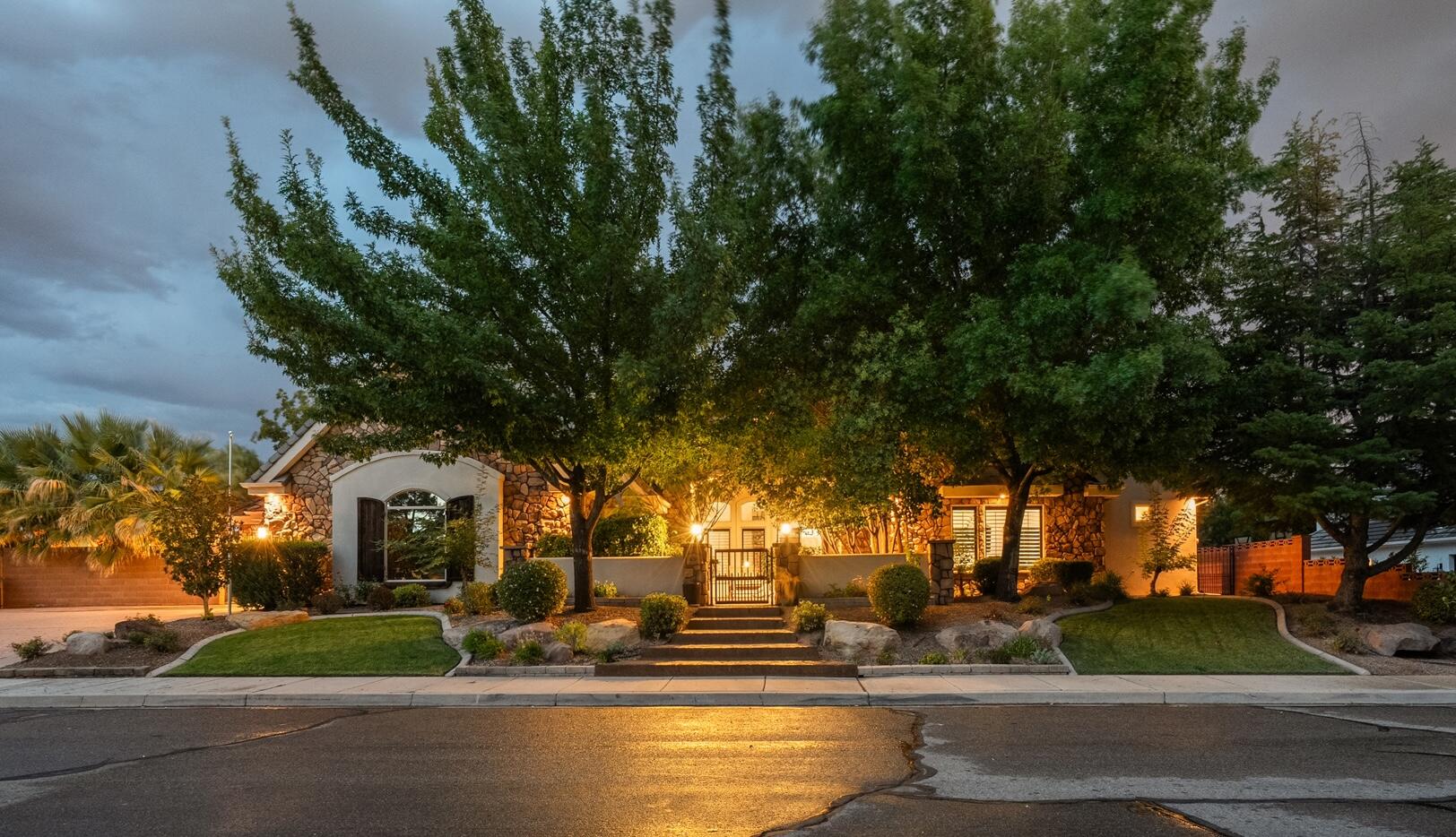Carpet allowance of $10,000 - this must be included in offer. Located in the quiet and secluded Cox Landing neighborhood near the heart of St. George, this exceptional custom home offers quality craftsmanship, luxury finishes, large mature trees and landscaping. Built with solid quality construction, featuring hardwood floors, solid wood bookcases and built-ins. This home is an entertainer's delight: Multiple spacious gathering areas, incredible indoor-outdoor living, and it's directly across from the beautiful Cox Park, which has a pavilion and restrooms. 

The gourmet kitchen is designed for entertaining with high-end custom cabinetry, gorgeous granite countertops, a Wolf gas range with wood hood, pot filler, brand-new double ovens, Sub-Zero refrigerator/freezer, and a curved bar with seating for up to eight. The large dining area can accommodate a 12'+ long dining room table. The spacious primary suite includes a sitting room or den, roll-in steam shower with double shower heads, jetted tub, and a large walk-in closet with stackable washer/dryer.

The casita ADU offers an interior entrance and private exterior entrance, vaulted ceilings, kitchenette, full bath, and walk-in closet--ideal for guests or multigenerational living. Additional gathering spaces include a large basement family room with kitchenette.

The backyard is a private retreat featuring a heated and recently resurfaced saltwater pool with waterfall, hot tub, outdoor kitchen with BBQ and TV, gas fire pit, two covered patios, palm trees, lush mature landscaping, and a privacy wall with lighting for evening enjoyment. Truly an entertainer's dream close to the heart of St George. Come see it today!