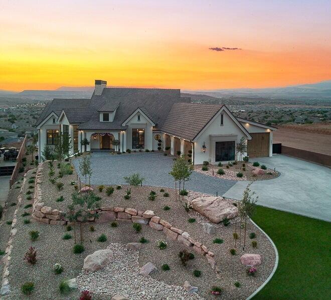 Welcome to this former 2025 parade home. An impressive luxury estate in Banded Hills professionally designed by ''Dwell Design'' and built by Split Rock Custom Homes. Thoughtfully crafted with timeless elegance, this expansive home is defined by soaring ceilings, custom millwork, and walls of glass that frame sweeping valley and mountain views, filling the interiors with natural light and stunning architecture. At the heart of the home, the gourmet kitchen stands as a true showpiece, featuring bespoke cabinetry, marble surfaces, professional-grade appliances, and a striking custom cast-stone cooktop. A farmhouse sink positioned beneath picture windows captures breathtaking views, while the open-concept layout flows seamlessly into the great room, anchored by a matching cast-stone fireplace The home offers a second kitchen, a flex room, a dedicated dog wash multiple laundry hookups, control 4, and a true office space. A fully equipped home gym with mirrored walls and a spa-like atmosphere flows seamlessly to the backyard oasis. Enjoy sunset views from the covered terrace with fireplace, entertain in the fully equipped outdoor kitchen with built-in BBQ, or relax poolside in the saltwater pool and spa. A private pickleball court and multiple lounge areas create an unparalleled setting for recreation and entertainment, all within a beautifully designed and private landscape with no HOA.