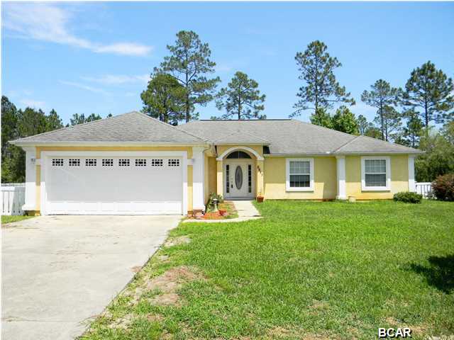 ATTRACTIVE 4 BEDROOM HOME ON 1/2 ACRE. The interior of this home features 4 bedrooms, 2 full bathrooms, an open floor plan, split bedrooms, a 2 car garage with attic storage, hardwood flooring, high ceilings and ample natural light. The living room has a wood-burning fireplace with mantle and decorative niches. The kitchen boasts ample counter and cabinet space, a tiled back splash, a built-in pantry, a breakfast bar and all white appliances. The master bedroom can accommodate King Size furniture and has a 11x7 walk-in closet, tray ceiling, hardwood flooring and an adjoining master bathroom. The XL master bathroom has a counter height vanity with 2 sinks, a Jacuzzi tub and a separate shower. The additional 3 bedrooms are good size. The laundry room has cabinets for extra storage. The exterior features a 1/2 acre lot, a fenced backyard, additional land behind the fence, a screened-in porch, a sprinkler system and a yard building. Call today for your own private preview. All ages, sizes and measurements approximate; buyer to verify if important.