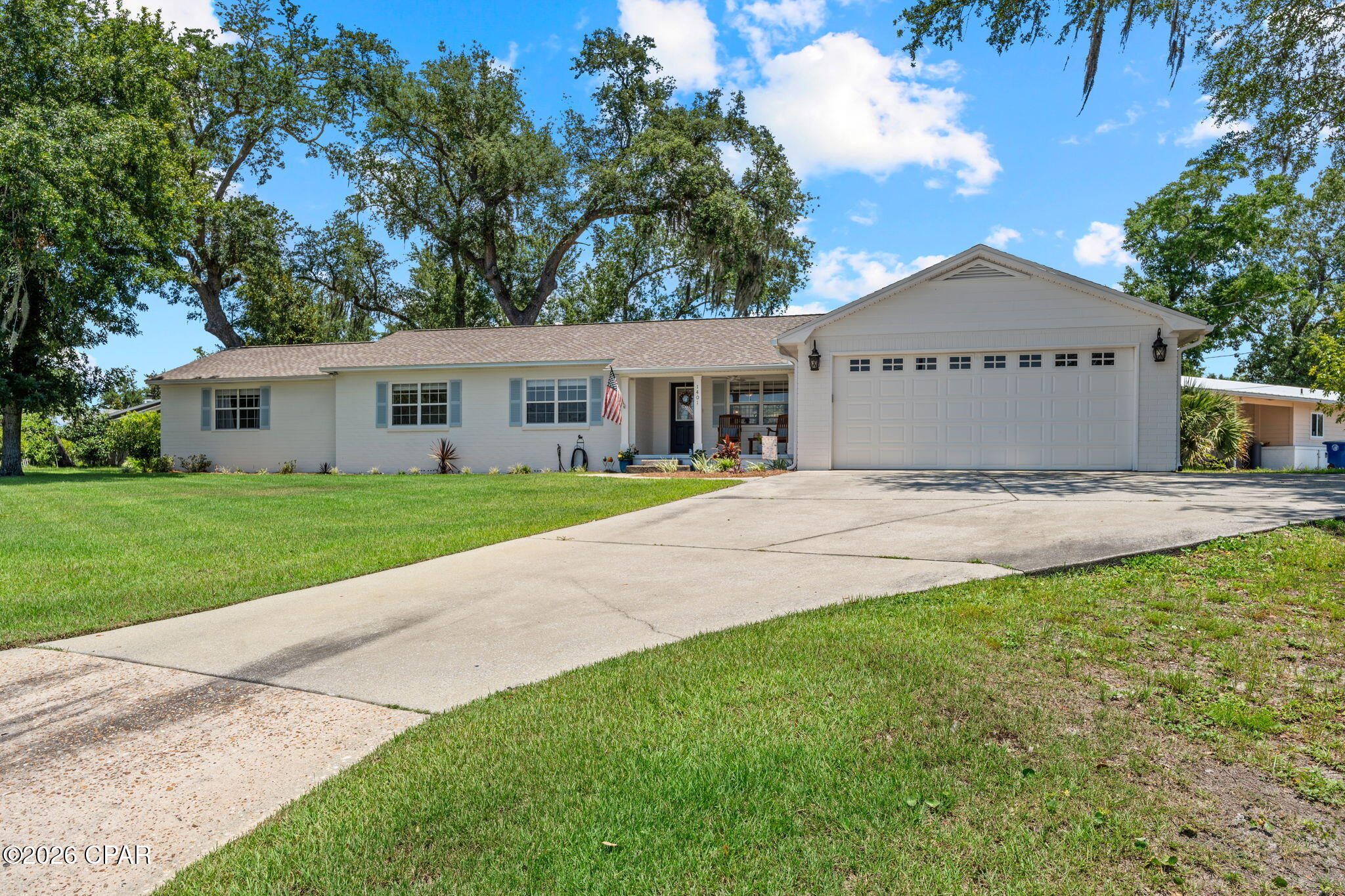 Over 2,100 square feet, 4 bedrooms, 2.5 bathrooms and a 2-car garage in The Cove? Opportunities like this rarely come along. Situated on a large corner lot in desirable Cove Terrace, this charming home offers bayou views from the front, an expansive primary suite, three additional bedrooms, a versatile bonus room, and two incredible backyard patios beneath some of Panama City's most beautiful oak trees. Originally built in 1951 and thoughtfully expanded over the years, this distinctive home blends timeless character with the space today's buyers are looking for. Beautiful original hardwood floors, abundant natural light, and thoughtful updates create a warm, inviting feel throughout. The oversized primary suite provides a private retreat, while the bonus room is ideal as a home office, fitness room, media room, playroom, or hobby space. Step outside to enjoy two spacious patios designed for entertaining, grilling, or simply relaxing in the shade. The large corner lot, mature landscaping, and magnificent oak trees create a setting that's both private and welcoming. This golf cart-friendly neighborhood is known for its historic charm, tree-lined streets, waterfront parks, and convenient access to downtown Panama City, dining, shopping, schools, St. Andrews Bay, and the marina. If you've been searching for a home with character, generous living space, four true bedrooms, a 2-car garage, and an unbeatable location, this is an opportunity you won't want to miss.