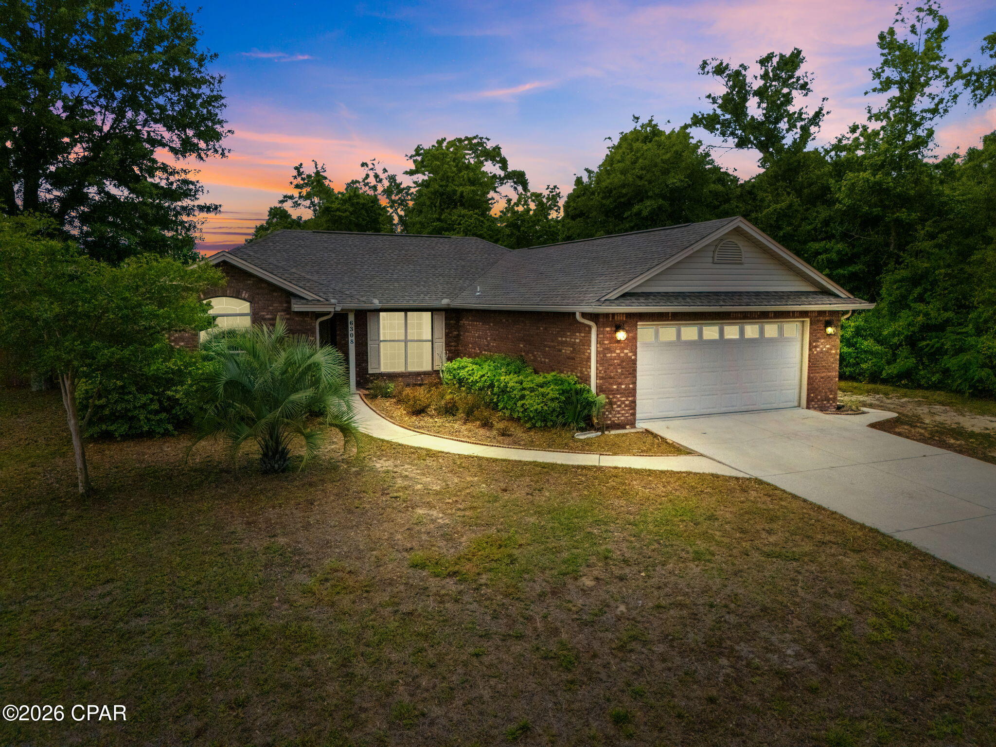 Under Contract - Taking Backups the phrase 'CURRENTLY UNDER CONTRACT, SELLER WILL CONSIDER BACKUP OFFERS. Looking for a move-in ready home in Panama City, FL that offers privacy and acreage views without the long commute? Welcome to 6308 Dune Creek Way. This stunning 3-bedroom, 2-bathroom home sits on a 0.25-acre lot featuring a rare, serene backdrop of neighboring horses. This home has a brand new roof (2026), and a new-ish water heater. Enjoy the peace of country living while staying minutes from schools, grocery stores, and Tyndall AFB. This open-concept floor plan is designed for modern lifestyles, offering vaulted ceilings and real hardwood flooring throughout the living areas and bedrooms. Equipped with stainless steel appliances, beautiful wood cabinetry, a functional breakfast bar, and a separate pantry, including a dedicated laundry room, fireplace, and ceiling fans in every room for maximum comfort. The primary suite is a  true sanctuary featuring tray ceilings, hardwood floors, and the ensuite features a double vanity with makeup station, cultured marble countertops, a glass-framed walk-in shower and a double walk-in closet. There is also a 2-car garage with attic storage. This home is located on a Cul-De-Sac road, with no HOA.  Buyer to verify all information and measurements. Some photos may be virtually staged to show the home's full potential. No furniture is included in the sale.