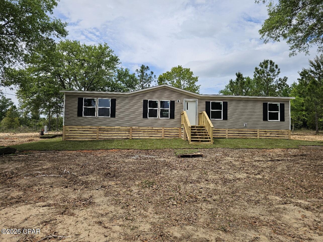 Brand-new 2026 manufactured home on over an acre in the scenic Compass Lake in the Hills community. This spacious 4-bedroom, 2-bath home offers a bright, open layout with modern finishes and a 10x20 covered deck at the rear--perfect for outdoor living. It comes with a one-year manufacturer warranty for peace of mind. Surrounded by wildlife and lakes, residents enjoy a welcoming community featuring a clubhouse and a wide range of amenities. Very affordable living, with community dues starting as low as $135 per year.  Some photos are virtually staged.