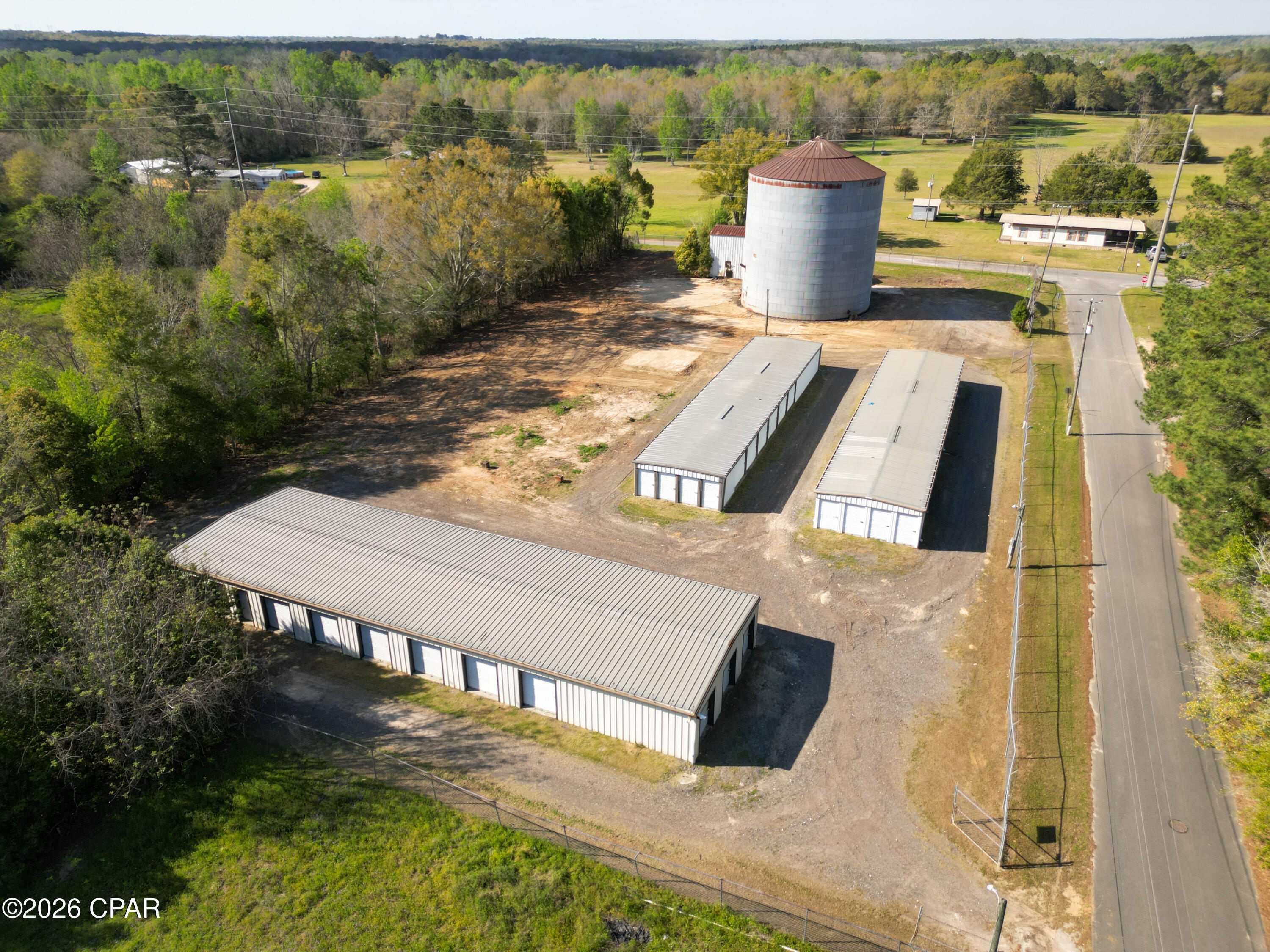 CURRENTLY UNDER CONTRACT - SELLER WILL CONSIDER BACKUP OFFERS!!! Looking for an investment opportunity with immediate cash flow? This well-maintained storage facility offers 7,000 square feet of storage space across three buildings and is currently about 80% occupied, providing steady income from day one.

The property features 66 total units in a variety of sizes, including 10x20, 10x10, and 5x10 units, appealing to a wide range of tenants. Even better, there is plenty of room to expand and add additional units, giving investors the opportunity to significantly increase revenue.

The fully fenced parcel adds value and flexibility, with the option for a new owner to implement controlled access or gated entry systems if desired. The subject property has already been divided from the parent parcel and includes the existing fenced area. Additional adjoining property is also available for purchase, offering even more room for expansion if desired.

Also included is an old grain bin (no longer in use) and a covered pole barn with open space underneath, formerly used for grain operations--offering additional storage potential or the opportunity for creative repurposing.

Whether you're looking to grow your investment portfolio or step into a turnkey income-producing property with upside potential, this one checks all the boxes!