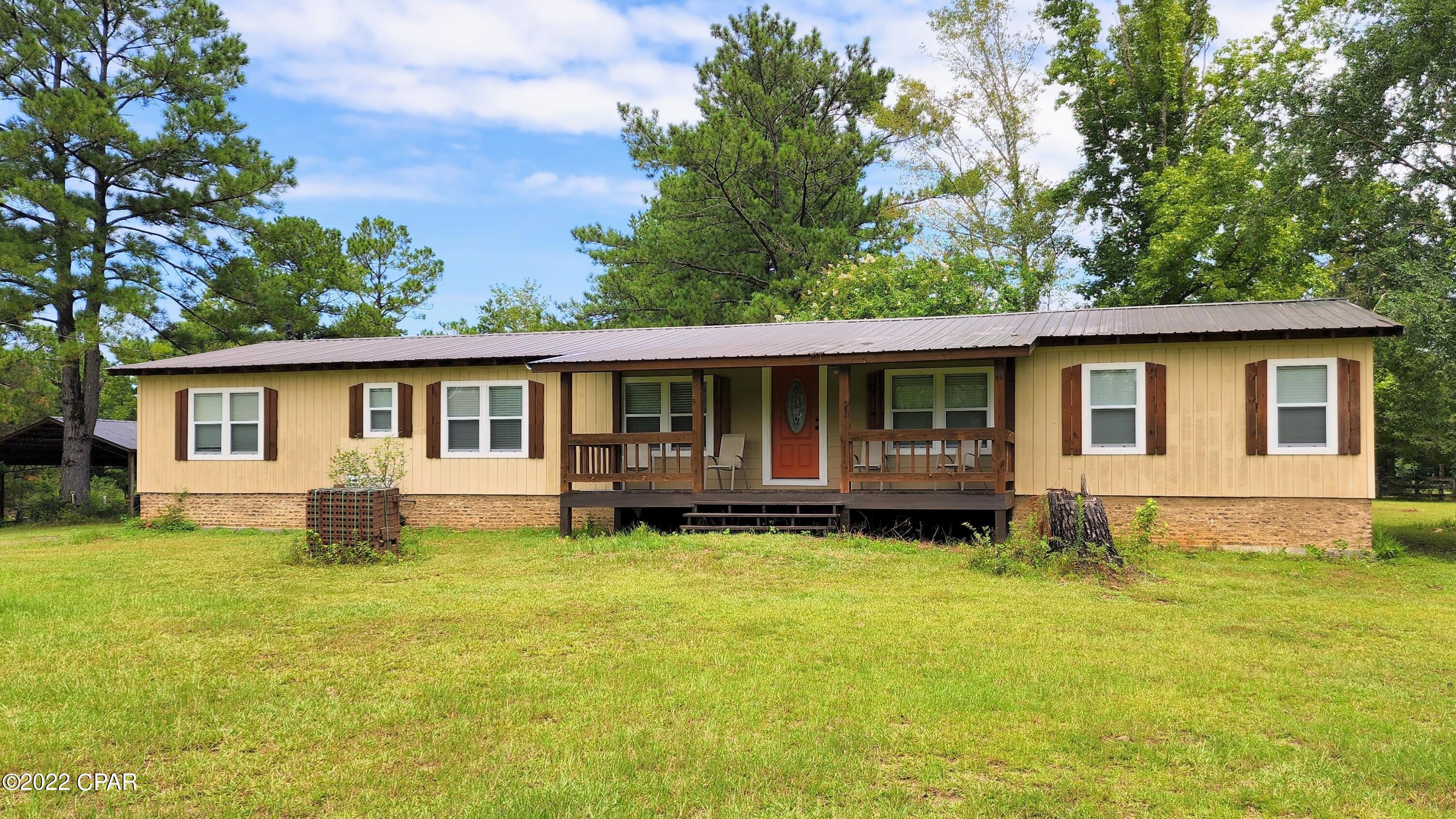Come see this beautifully transformed 3BD/3BA home on 21+ acres. Fully renovated with updated everything: wood siding, windows, roof, insulation, doors, flooring, well pump, stainless appliances, farmhouse sink, modern fixtures, recessed lighting, fireplace, vanities, toilets, tiled showers/bath, and the list goes on. The mini-split, ductless HVAC system keeps the home cool and electric costs low. Enjoy relaxing on the covered front porch or large back patio. There's also a 60'x36' pole barn to store your outdoor equipment. It's located only 20 minutes to shopping, restaurants, and medical care. It's less than an hour to PCB's Pier Park, ECP Airport, and the beautiful 30A Beaches. Schedule your showing today!