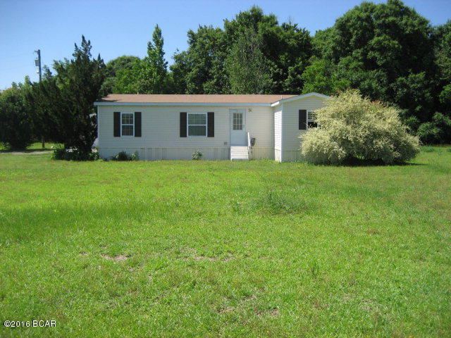 $65,000. PRICE JUST REDUCED $4,000! See this comfortable 2 or 3 BR double-wide mobile home on 2.75 acres, only 1.5 miles from small town. Built in 1997, this mobile home has 1,150 sq. ft. of living space, plus a 24' x 24' detached garage with automatic door opener, and a 12' x 20' shed with attached covered 20' x 20' carport, and an additional 20' x 20' open concrete pad. There is a handicap accessible ramp into the back double doors. Large living room, master bedroom, kitchen, laundry, 2nd bedroom, and 2 bathrooms. Originally the home had 3 BR's, but the current owners opened up one wall and made the 3rd BR into a formal dining area. (It would be simple to replace the wall and put the BR door back in place to convert the home back into 3 BR's.) The home is all electric, with central heat and air, as well as electric cook stove and electric hot water heater. Located just 3 minutes from town, yet it has a nice country feel. This is a very convenient location for most buyers. Due to health reasons, this owner has decided to sell. Annual taxes with Homestead Exemption are presently just over $400. Depending upon buyer's type of financing, seller MAY consider making some minor repairs or giving a buyer credit if the offer is reasonable enough. SELLER IS TRYING TO SELL THIS PROPERTY AS A SHORT SALE. $65,000.