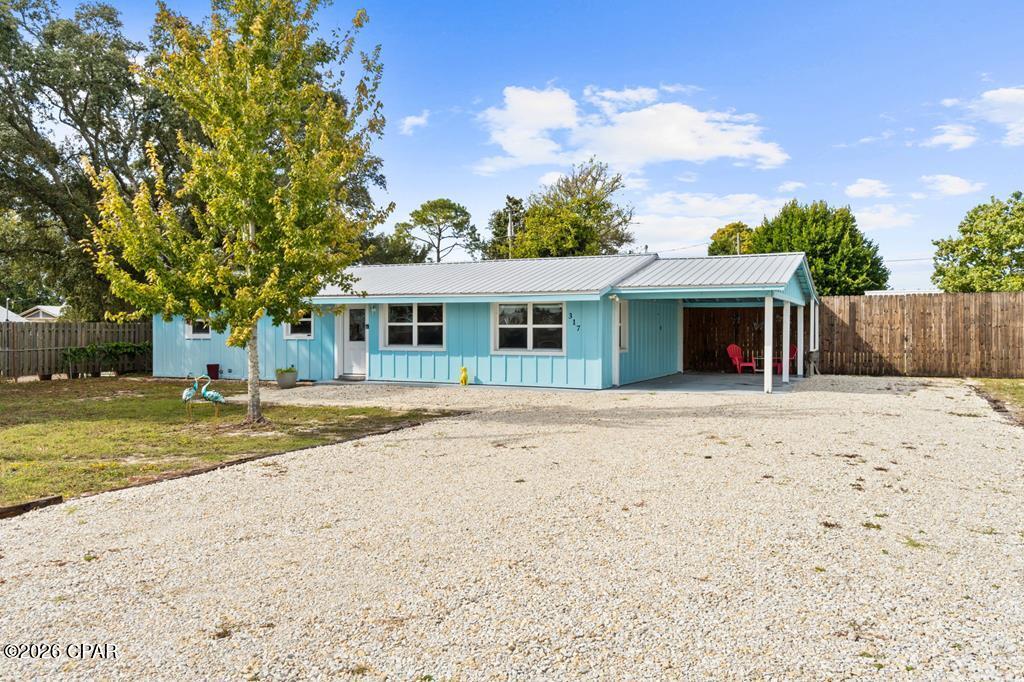 Welcome to 317 Canal Street, a 3BR/1.5BA beach cottage just a short walk or golf cart ride to the white-sand beaches in St. Joe Beach. Sitting on an oversized 0.34-acre lot (97x150), this property has plenty of space and flexibility--perfect for a full-time home, beach getaway, or income-producing rental. The home was fully updated after Hurricane Michael with new siding, roof, windows, cabinets, countertops, and paint, giving it a fresh, modern look while keeping its coastal feel. Inside, you'll find tile flooring throughout, soft-close cabinets, quartz countertops, and an open layout that feels bright and inviting. It's being sold fully furnished and already has a strong rental history, bringing in nearly $50,000 in gross income in 2024 and $41,000 in 2023. Impact windows add peace of mind and energy efficiency, and the large fenced backyard is perfect for entertaining, relaxing, or even adding a pool. There's covered parking under the carport and extra space for a boat or golf cart. With its great rental performance, oversized lot, and prime location near beach access, 317 Canal Street checks all the boxes for easy living and solid investment potential. Call Today!