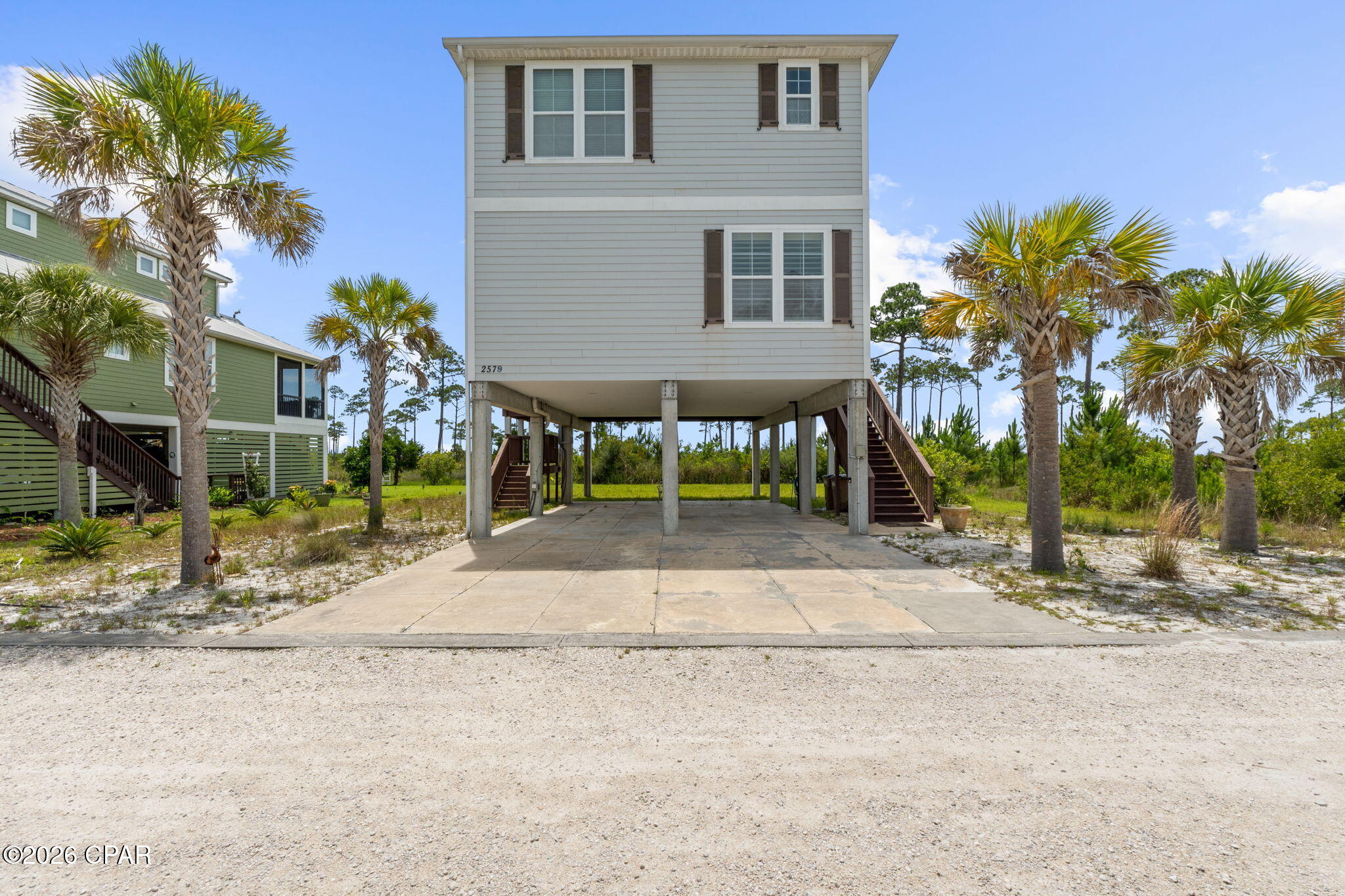 BAYSIDE SUNSET BLISS!!   Experience the best of the Forgotten Coast at 2579 SR 30A, where breathtaking sunsets, coastal adventure & laid-back living come together in perfect harmony in this 4-bedroom/3-bath home home.  Spacious living areas filled with natural light create a warm & welcoming atmosphere, while thoughtfully designed gathering spaces allow family & friends to comfortably come together after a day on the water. The well-appointed kitchen serves as the heart of the home with an inviting layout that keeps everyone connected whether preparing meals, hosting guests, or enjoying a casual breakfast. Comfortable bedrooms provide peaceful accommodations, while multiple outdoor living areas invite you to embrace the coastal lifestyle year-round. Two screened porches expand the living space outdoors, offering the perfect setting for morning coffee, afternoon breezes, or evening cocktails as the sun sinks below the horizon. The impressive 970' elevated community boardwalk stretches above the shoreline of pristine St. Joseph Bay, providing stunning panoramic views & direct access to one of Florida's most treasured natural resources. At the end of the walkway, a large platform with steps to the water creates the ideal launch point for kayaking, paddleboarding, fishing, scalloping, birdwatching & exploring the bay's abundant wildlife. Dolphins, shorebirds & marine life are frequent visitors, making every outing an unforgettable experience. Perfectly positioned between St. Joseph Bay & the Gulf of Mexico, this property places you just minutes from the sugar-white beaches of Cape San Blas.  Downtown Port St. Joe offers waterfront dining, local seafood restaurants, boutiques & coffee shops that capture the charm of small-town coastal living. Whether you're searching for a primary residence, vacation getaway, or investment property, this coastal retreat delivers comfort, convenience & endless opportunities. Call for your private tour & LIVE THE BEACH LIFE!