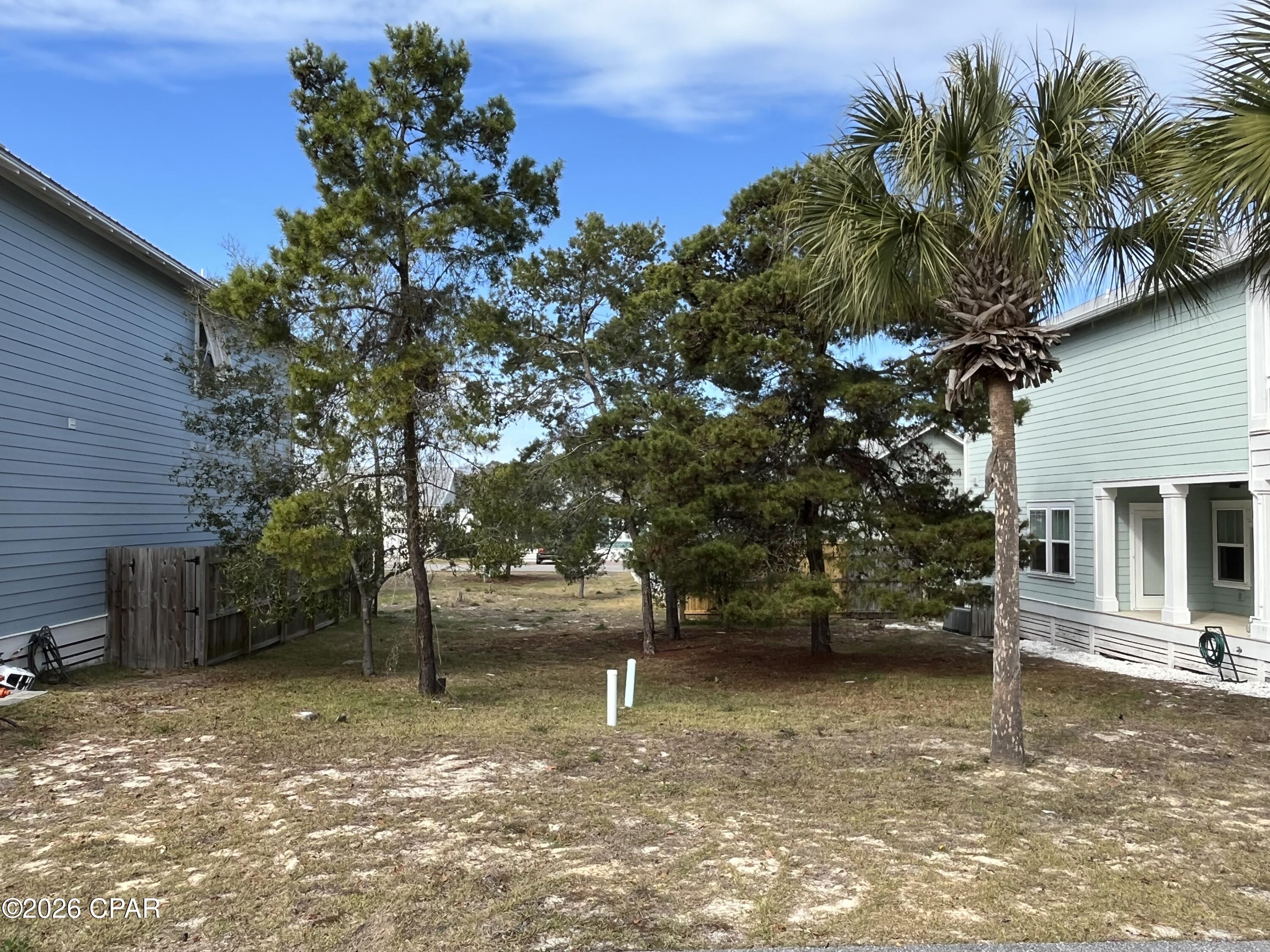 Build your dream beach home in Paradise Grove, a non short term rental community on the west end of Panama City Beach. This cleared, build-ready lot is located in a charming neighborhood of cottage-style homes and offers an excellent opportunity to create your own coastal retreat. Residents enjoy a gated entrance, well-maintained common areas, and a community pool. Conveniently located just four blocks from the beach, minutes from Pier Park, and a short drive to 30A and Northwest Florida Beaches International Airport, this property offers the perfect setting for a primary residence, second home, or long-term investment on the Emerald Coast.