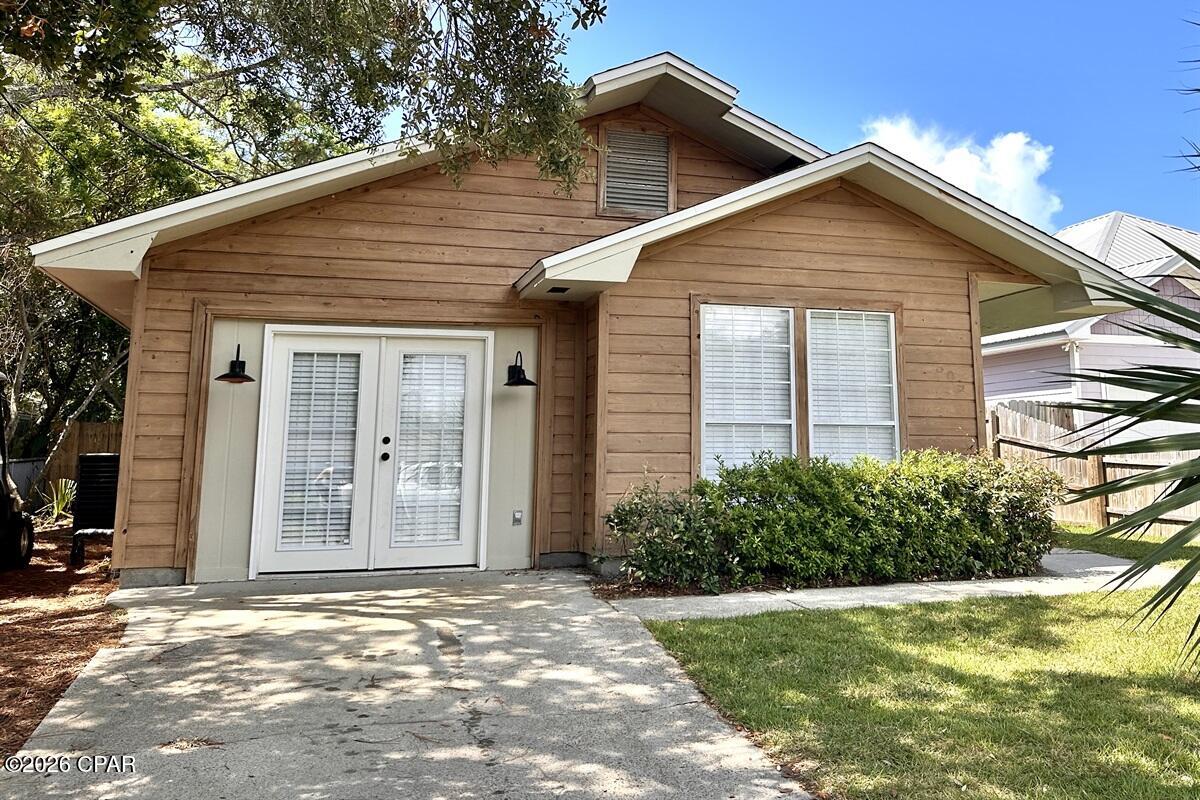 Completely renovated in 2023 and designed with today's buyer in mind, this turnkey 3 bedroom, 2 bath beach cottage offers the ideal blend of style, comfort, and income potential in the heart of Panama City Beach. With 1,295 square feet of thoughtfully updated living space, this property is already operating as a successful short-term rental and is perfectly suited as an investment property, second home, or full-time coastal retreat.

Step inside to a bright, open-concept floor plan featuring vaulted ceilings with exposed wood beams, recessed lighting, and luxury plank flooring throughout. The living area flows seamlessly into the dining space and kitchen, creating an inviting atmosphere for gathering and entertaining. The beautifully updated kitchen offers crisp white cabinetry, quartz countertops, open shelving, modern hardware, stainless appliances, and a large island overlooking the main living space.

The primary suite is a peaceful retreat with abundant natural light and a spa-inspired en suite bath featuring dual vanities, sleek fixtures, and a stunning tiled walk-in shower. Two additional guest bedrooms and a fully updated second bath provide comfortable accommodations for family and guests, maximizing rental flexibility.

Outdoor living is where this home truly shines. A screened-in patio extends the living space and offers the perfect spot for morning coffee or evening cocktails. The fully fenced backyard is private and spacious, complete with a fire pit gathering area and ambient string lighting that creates an inviting coastal setting for guests. An irrigation system on well water helps maintain the lush lawn while keeping utility costs down.

The exterior showcases charming coastal cottage appeal with warm wood siding and thoughtful architectural details that set it apart. The manageable lot size makes ownership easy while still offering ample outdoor enjoyment.

Located just minutes from the white sandy beaches and only about 10 minutes to Rosemary Beach, this property offers exceptional short-term rental appeal in a highly desirable area near dining, shopping, and entertainment. With recent renovations, modern finishes, and an established rental presence, this is a true turnkey opportunity. Golf cart included.

Whether you are looking to expand your investment portfolio or secure your own beach getaway that can generate income when not in use, 21309 Caribbean Lane delivers both lifestyle and strong income potential in one beautifully updated package.