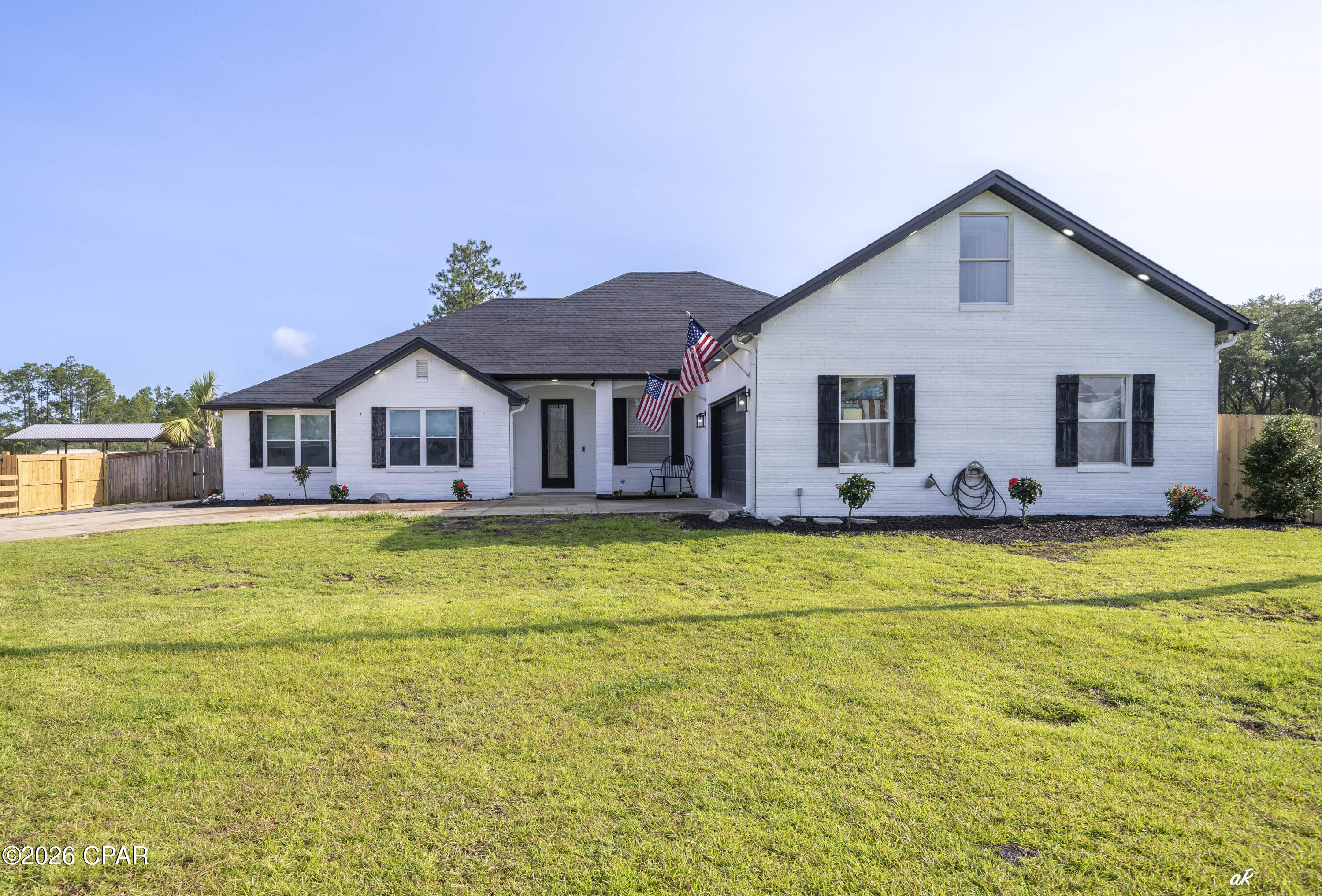 221 White Oaks Boulevard, where you can enjoy the space and freedom that draws so many people to Southport while still being just minutes from Lynn Haven, Panama City, and Panama City Beach. Situated on 3 acres across two parcels with frontage on both White Oaks Boulevard and Skunk Valley Road, this property offers flexibility that's hard to find. The approximately 4,000-square-foot home features 5 bedrooms, 2 bathrooms, multiple living areas, a formal dining room, an eat-in kitchen, a bonus room, and recent updates including flooring, appliances, and other interior improvements. Highlight- possible to split and make two separate properties, one on White Oak and one on Skunk Valley with two separate dwellings! Step outside and you'll quickly see what makes this property special. The backyard is set up for enjoying the outdoors with an in-ground pool, hot tub, outdoor kitchen, cabana, fire pit, basketball court, outdoor shower, pool bath, and a playhouse. Need room for projects, toys, or a business? The approximately 4,000-square-foot shop includes a vehicle lift and offers plenty of space for equipment, storage, hobbies, or a home-based business. The property also includes two separate one-bedroom apartments, providing excellent rental or guest accommodations, plus an RV site with full hookups for visitors or additional income potential. A private gym adds even more versatility. With no HOA and room to spread out, this is the kind of property that's becoming increasingly difficult to find. Whether you're looking for space for your family, a place to run a business from home, room for all your hobbies, or a property with built-in income opportunities, this one checks a lot of boxes. If you've been looking for country living without feeling isolated, you'll appreciate the location. Enjoy the peace and privacy of Southport while staying just a short drive from Lynn Haven, Panama City, boat ramps, shopping, restaurants, schools, and the beaches.Properties with this much land, this many improvements, and this level of versatility rarely come available. Schedule your private showing today.