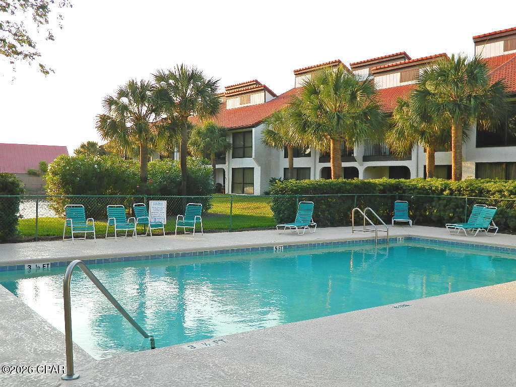 This ground floor layout is an extra-large end unit with three bedrooms at the iconic Edgewater Beach & Golf Resort. This spacious unit has floor to ceiling sliding glass doors that open to an oversized covered patio. There is easy care tile flooring and vinyl luxury plank throughout. A mirror wall in the living room increases the sense of room size (see photos for an example of modern frame update). All three bedrooms are spacious, inviting, and functional. The owner's suite has its own bathroom, walk-in closet, and patio access. The split floor plan puts the guest suite down the hall with its own bathroom, queen beds, and sliding glass door to a patio. The third bedroom offers access to the guest bath. There is a full kitchen with granite countertops, beachy-look white cabinetry and appliances, breakfast bar, dining area, and a convenient in unit laundry. This Villa is offered fully furnished; rental or move-in ready. With strong rental potential, a prime location near the street walkover and sports club, along with the privacy of the Villas, this property is ideal as a vacation home or rental investment. Owning a Villa at Edgewater means embracing a lifestyle centered around relaxation, recreation, and convenience. Enjoy tropical pools, hot tubs, splash pad, golf, pickleball, tennis, fitness facilities, on site dining and market, and private beach access--all within a gated, beautifully maintained resort. A personal beach retreat or rental investment with an active lifestyle focus.