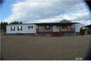 Possible Owner Financing!!!Country living at its best. Well maintained mobile home with large Florida Room. Large covered front porch, with screened porch on back. Split bedroom plan with kitchen open to living room. Home has metal roof and ready to move into. 24 X 36 Pole Barn. A must see!!!!