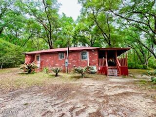 REDUCED! Home in peaceful setting with elbow room on 2 acres. Detached garage is 33x23 and has a new roll up door with plenty of space for a workshop. The home has stucco exteriormade to look like bricks. Roof is red metal. Home has been recently completely renovated. Upgrades include new floor covering, new countertops and refinished cabinets, refinished sheetrock, paint, new HVAC and duct work.  Relax and enjoy the hot tub just off the master bedroom. Kitchen has plenty of cabinet and counter space. Stove, fridge, microwave, washer/dryer stay. Large, covered deck at the side entrance. Many large oak trees in the yard.