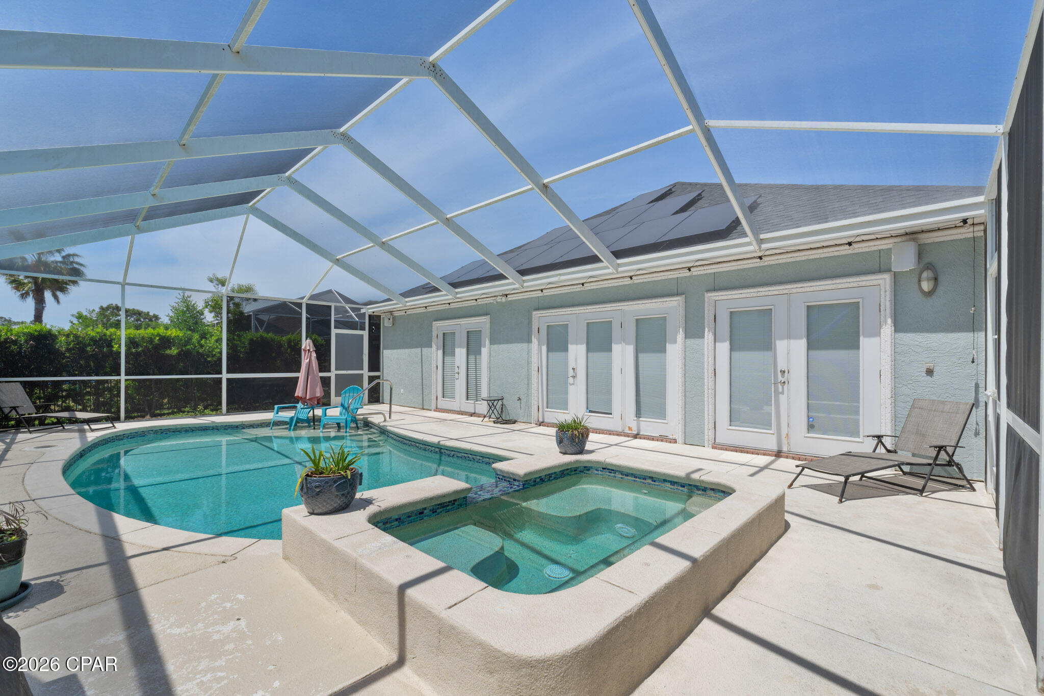 OPEN HOUSE THURSDAY JUNE 11TH BETWEEN 3:00-5:00pm.  Rare Opportunity in Exclusive Tierra Verde - Panama City Beach

Discover this beautifully maintained 3-bedroom, 2.5-bath executive ''GREEN HOME'' in the prestigious Tierra Verde subdivision--a gated enclave of just 24 homes within The Glades community. Centrally located, Tierra Verde offers easy access from Back Beach Parkway and Middle Beach Road, and its golf cart-friendly streets lead you straight to the white sandy beaches, local restaurants, and Duplin Winery. You'll also be minutes from world-class golf courses, Pier Park, Dolly Parton's Pirate Dinner Theater, Top Golf, popular dining spots, entertainment venues, and community parks.

Situated on a quiet cul-de-sac behind a private security gate, this 2,362 sq. ft. home blends luxury with energy efficiency. The open-concept living area features 12-foot tray ceilings with crown molding and cove lighting, electricity provided through solar energy, a cozy gas fireplace, and tile floors throughout. The custom designer kitchen boasts brand new unique curved Quartz countertops, stainless steel appliances (new stove & microwave in 2023), and beautiful cabinetry.

The spacious primary suite offers private pool access, tray ceiling with cove lighting, his-and-hers closets, and a spa-like bath with brand new granite double vanity countertops, jetted tub, water closet, and large custom-tiled shower. Additional highlights include a dedicated office with French doors, built-in shelving, and a driveway-facing window.

Step outside to a screened-in lanai with a saltwater pool, overflowing spa, and tanning deck--perfect for relaxing or entertaining. The oversized driveway, two-car garage, and separate golf cart garage provide ample parking and storage.

Recent Updates & Upgrades:

Roof: Replaced June 2024,

HVAC: Replaced December 2024,

Gutters: Replaced December 2024.

Solar Panels: New with transferable warranty--significant energy savings.

Pool Screen: Replaced January 2025,

Pool Deck: Refinished April 2025,

Pool Light: Replaced May 2025.

Kitchen / Baths Countertops Replaced April 2026

If you're seeking a move-in-ready home in a prime location with luxury finishes, modern upgrades, and low maintenance, this is a rare find you won't want to miss.  Seller is willing to remove solar panels with acceptable offer if you are not interested in solar energy.  HOA includes monthly trash service.