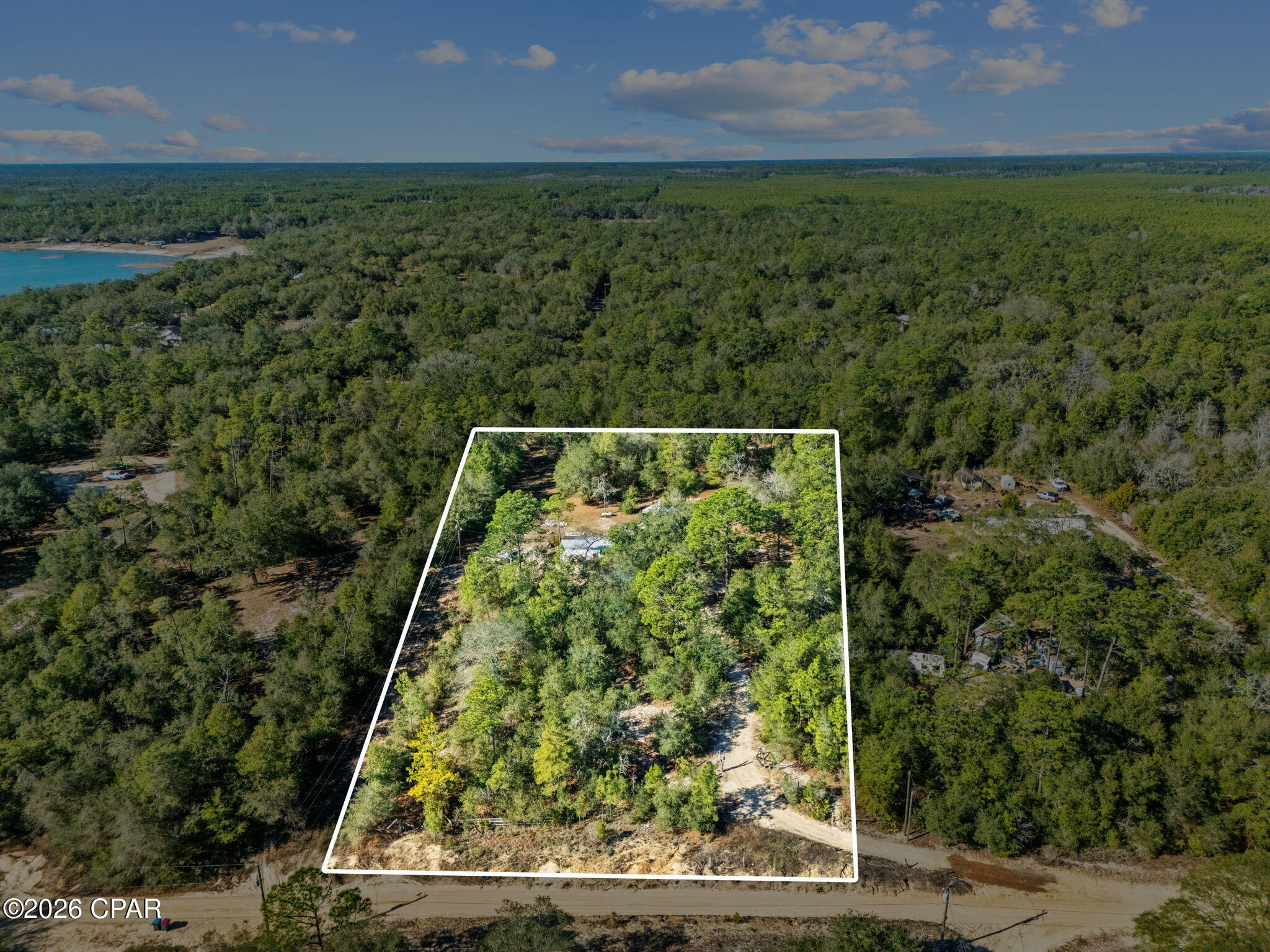 Tucked away on a dirt road in Southport, this 2.5 acre parcel offers a blend of privacy, natural beauty, and convenience. The land is truly the star here, dotted with stunning mature oak trees that create a peaceful sense of separation from the everyday hustle.

A residential structure is present on the property and conveys at no value, sold as-is, providing a canvas for those looking to build, reimagine, or invest in the land itself. The expansive acreage allows room to design a homesite that embraces the surrounding nature while maintaining space and seclusion.

Despite the tucked-away feel, the location is highly practical. Dean Bozeman Schooll is approximately 5 minutes away, with restaurants, grocery stores, coffee shops, and additional shopping options reachable in 15-25 minutes. The world-famous beautiful beaches of the Emerald Coast are roughly 30 minutes away, making coastal days easily accessible while enjoying a more rural setting at home.

Call a REALTOR today to schedule a private property tour. If important, please verify al measurements.