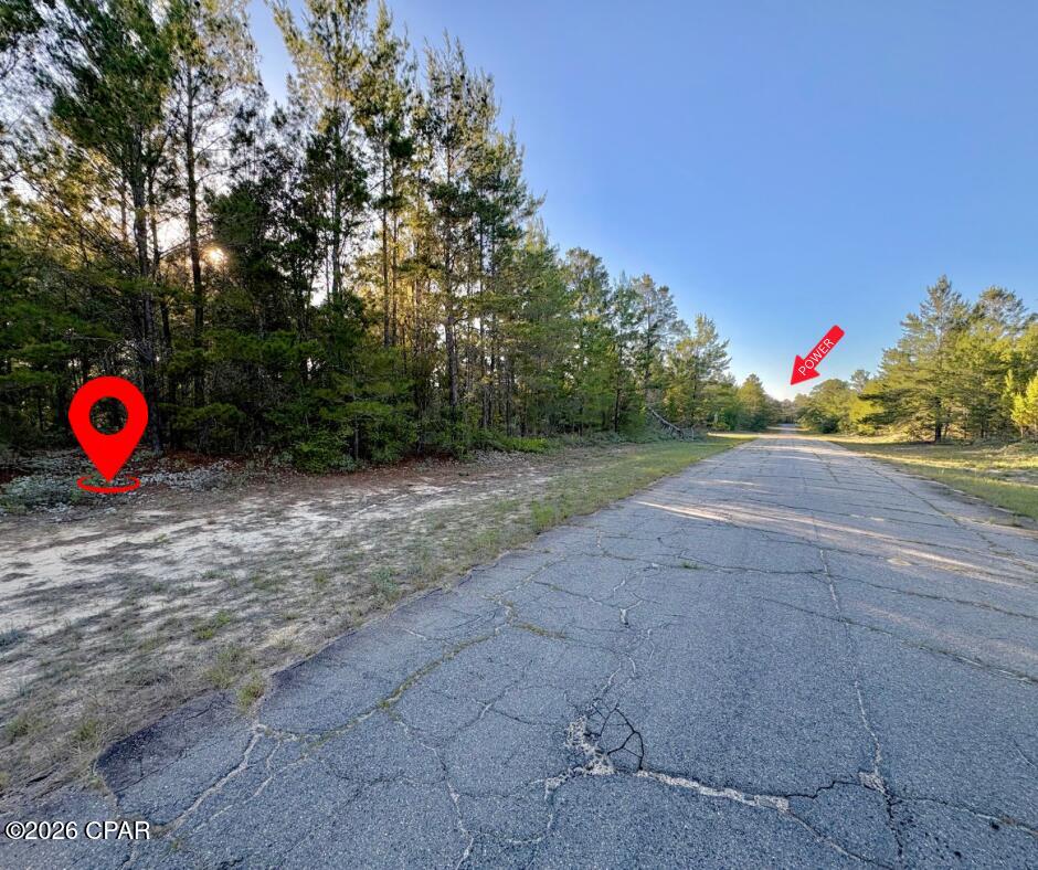 Lightly wooded lot located in the peaceful and scenic Sunny Hills community. There are power lines located at the end of Yarmouth on the corner of Yarmouth and Randolph, less than one thousand feet. For nature lovers and outdoor enthusiasts, Gap Lake has great fishing and is not too far away either, it is an 800+ acre freshwater paradise. Enjoy serene views of majestic cypress trees and experience excellent fishing opportunities right in your neighborhood. Additionally, a county boat ramp on Gap Lake makes for easy access to all your water adventures. Sunny Hills is a growing golf course community with a lot of new construction happening. It's ideally situated just under 30 minutes from both Chipley, Lynn Haven, and the airport- offering the best of both worlds: a slower, laid-back lifestyle while still being close to city amenities. Plus, you're less than an hour away from the white sands of Panama City Beach! Sunny Hills also offers many freshwater lakes for fishing and boating and also a swim park at spring-fed Boat Lake for seasonal fun. This deed-restricted lot is reserved for building only, ensuring a well-maintained community without the burden of HOA fees. Enjoy the tranquility and convenience of life in Sunny Hills! Buyer to do their own due diligence about getting utilities on the property. Buyer to pay for owner's title policy/title fees.