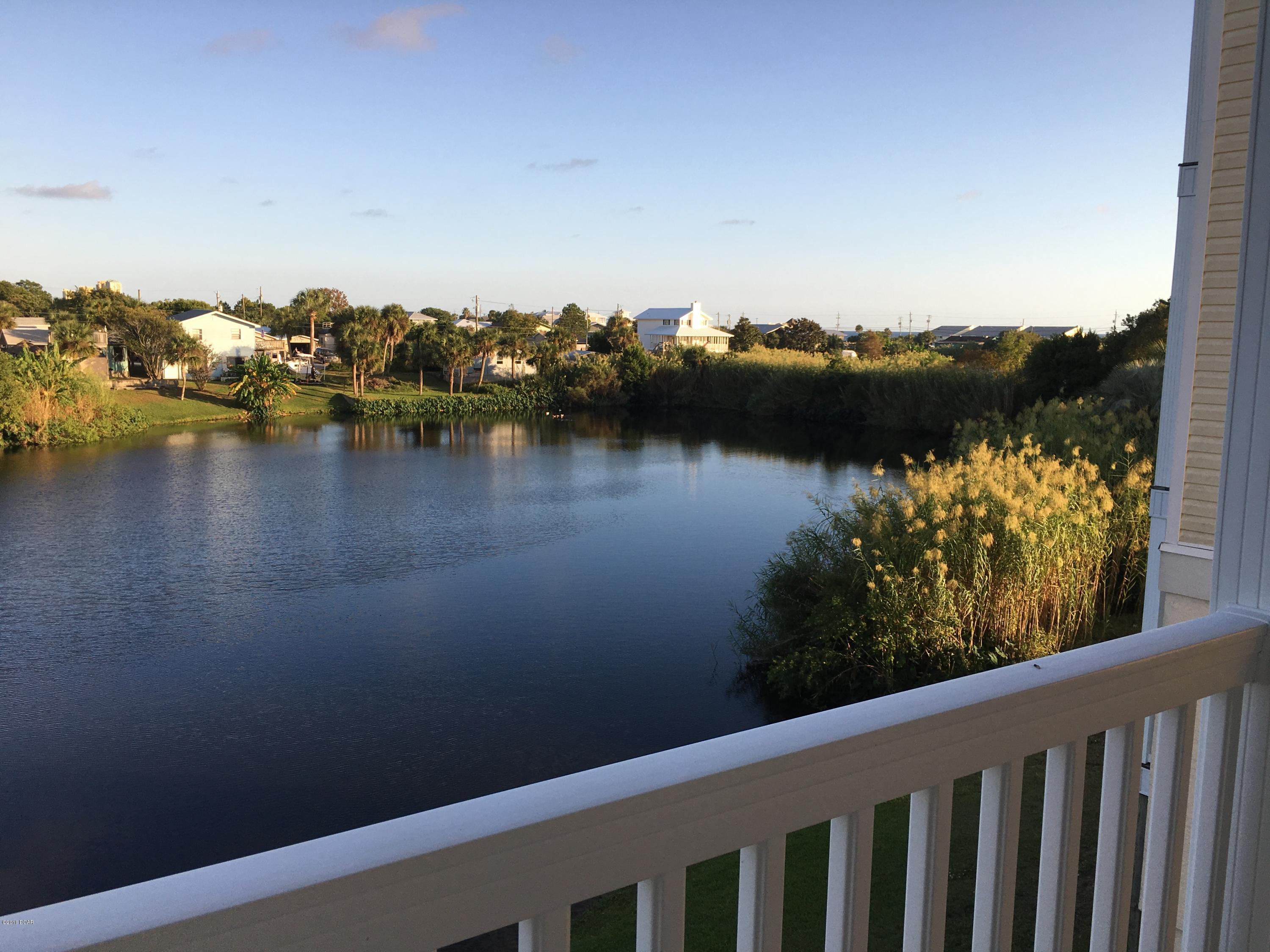 You'll enjoy beautiful views of a spring-fed lake and the gulf from three separate balconies in this spacious 4-bedroom, 3.5 bath house. The property contains a lock-out unit on the ground floor with a private entrance, bedroom, full bath, laundry room and small refrigerator. The interior and exterior of this home are very clean and well-maintained. The house is located on about 30-feet of lakefront. If you're a nature lover, you'll appreciate the lake's habitat for carp, ducks and turtles.